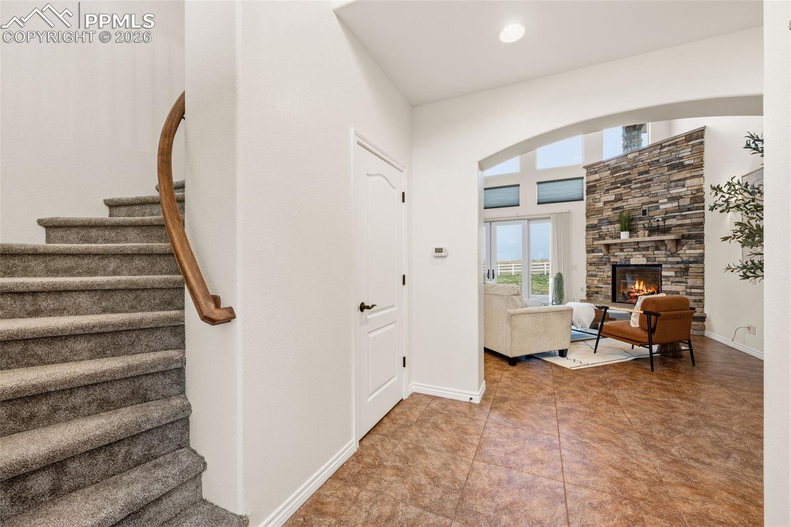 Curved staircase leads up to loft, bedroom, and full bath