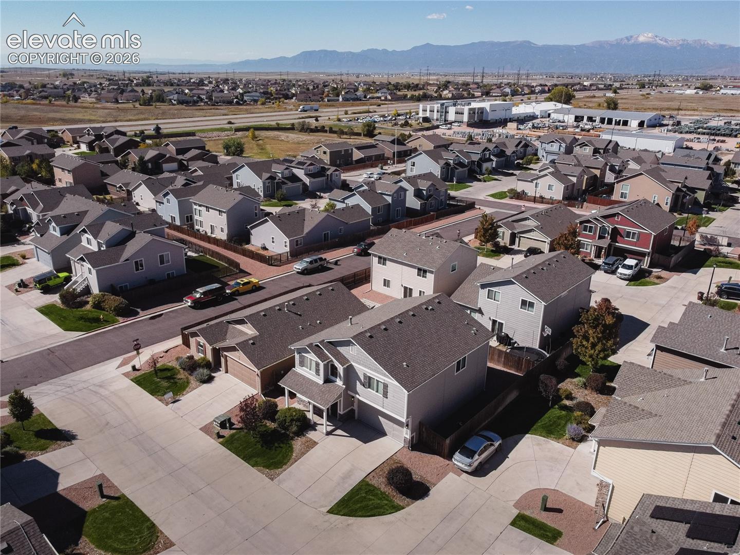 Residential neighborhood with varied architectural styles and mountain scenery