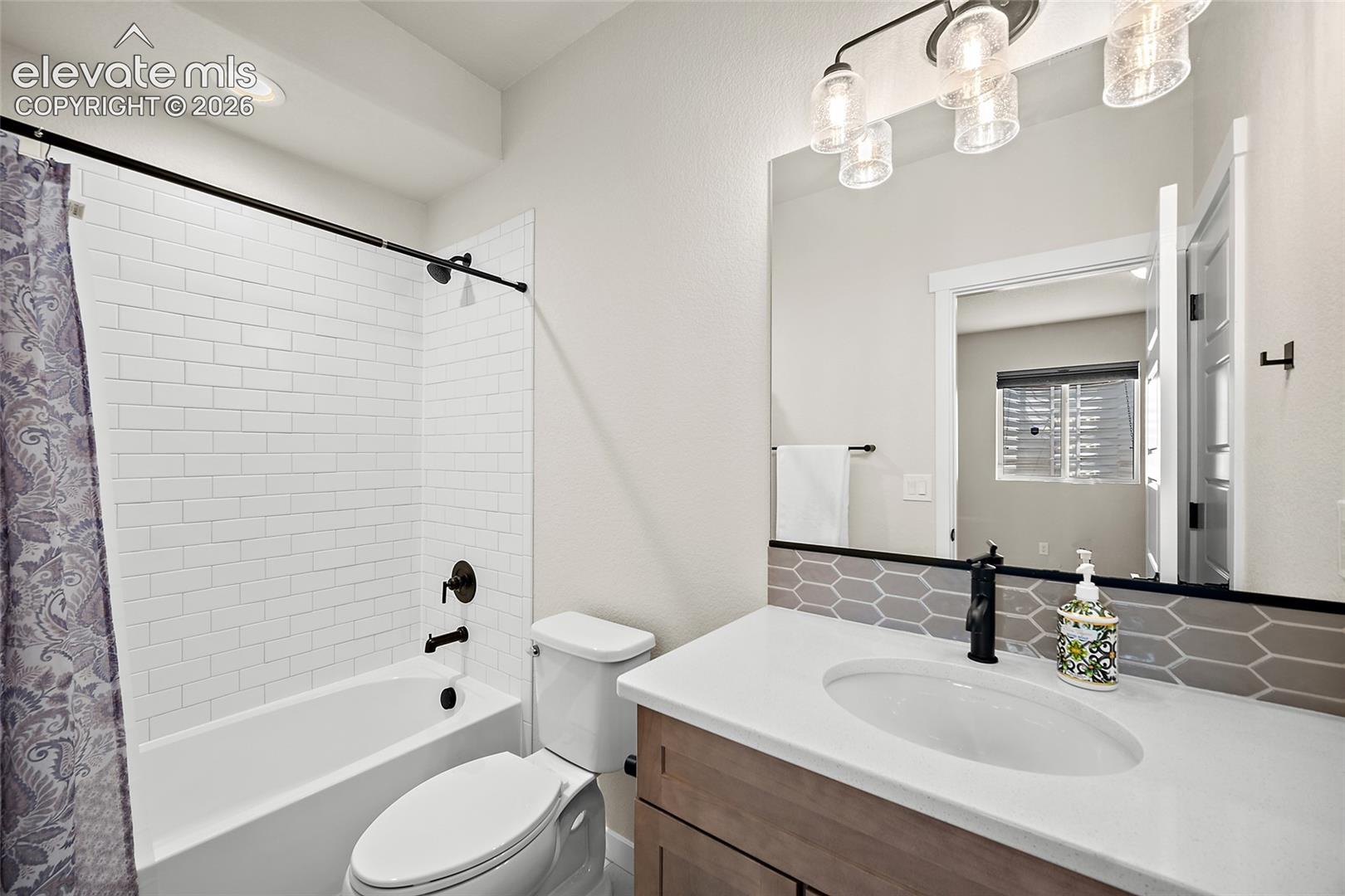 Subway tile shower surround with quartz counters