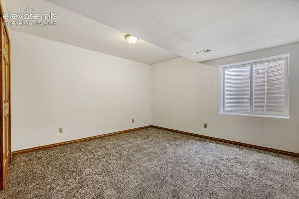 Room featuring new neutral-toned carpeting, white painted walls, and wood trim