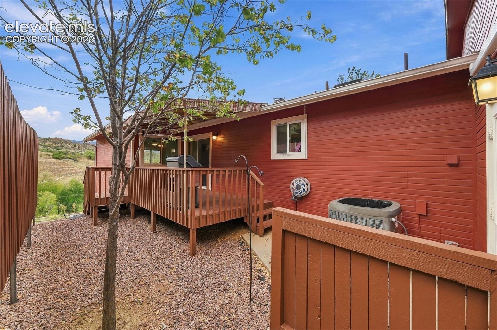 Side of home with air conditioner. 