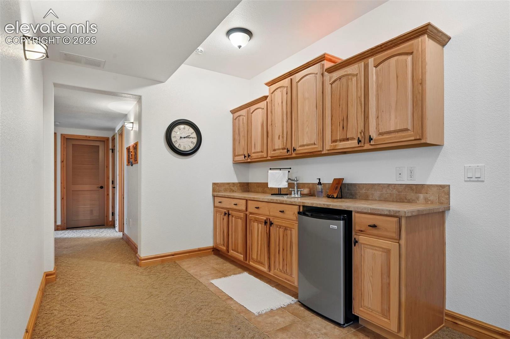 Wet bar with mini fridge that conveys