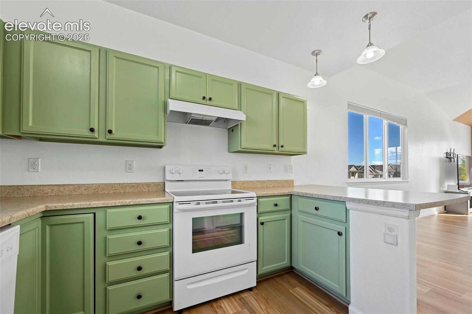 Kitchen featuring painted cabinetry, stone-finish countertops, an integrated range with an overhead ventilation hood, dual pendant lighting, and wood-finish flooring