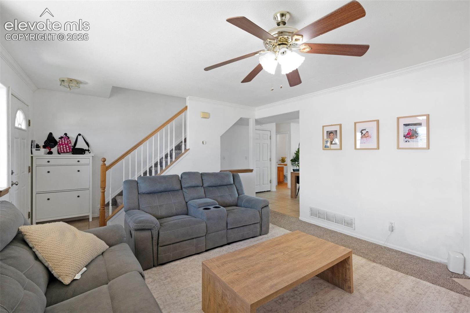 Living area featuring light-toned carpeting and white wall finishes