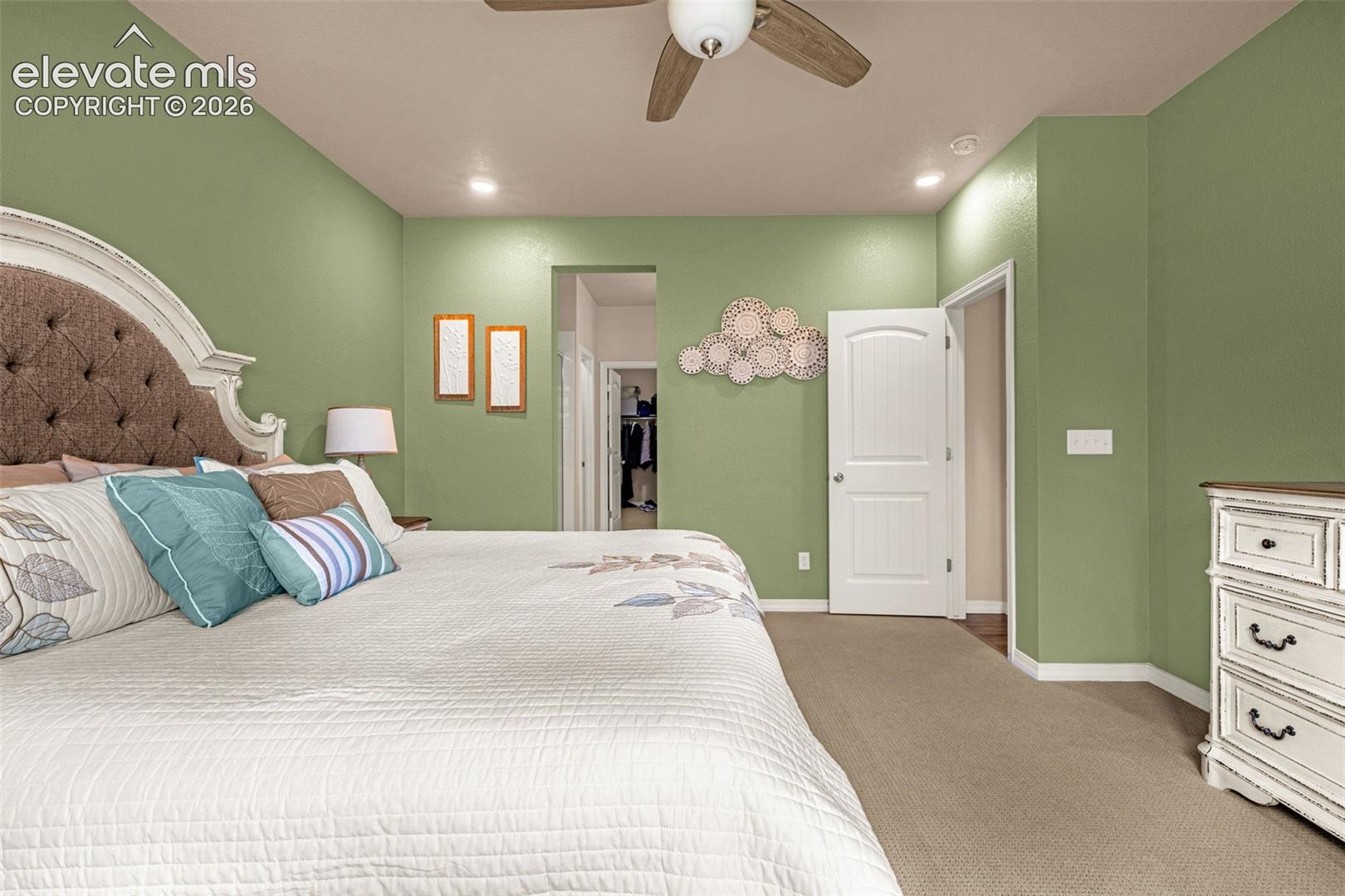 Recessed lighting, ceiling fan, and painted interior walls