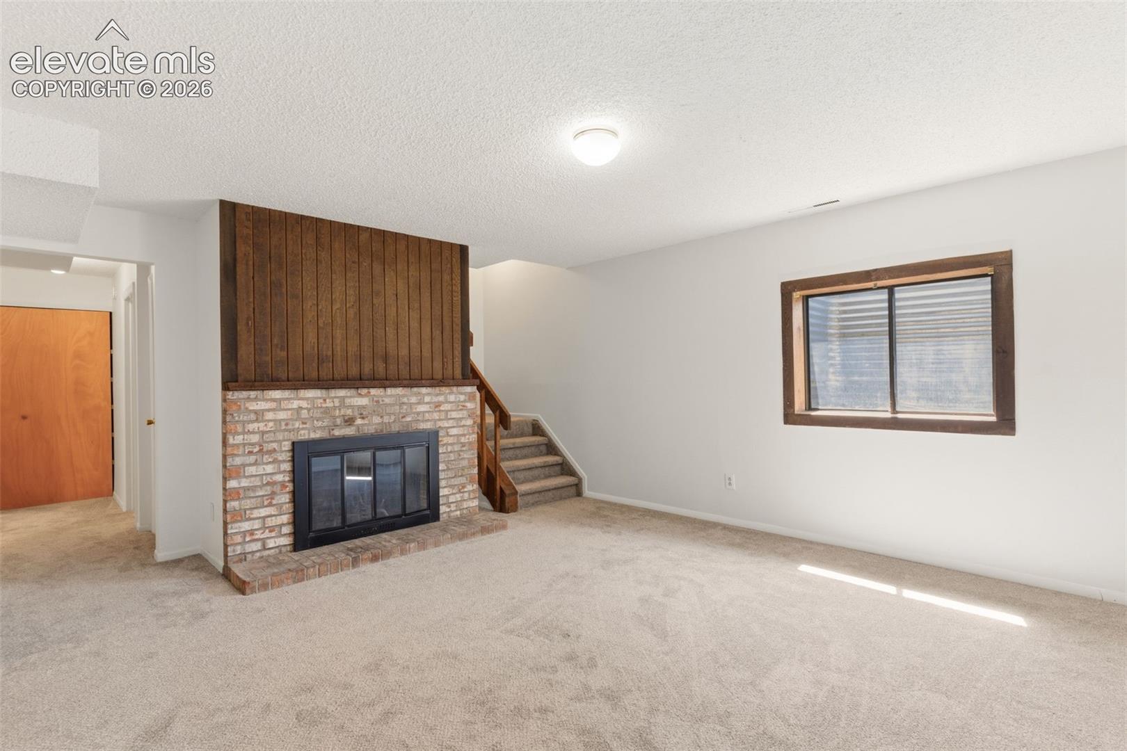 Basement Family Room w/ wood burning fireplace