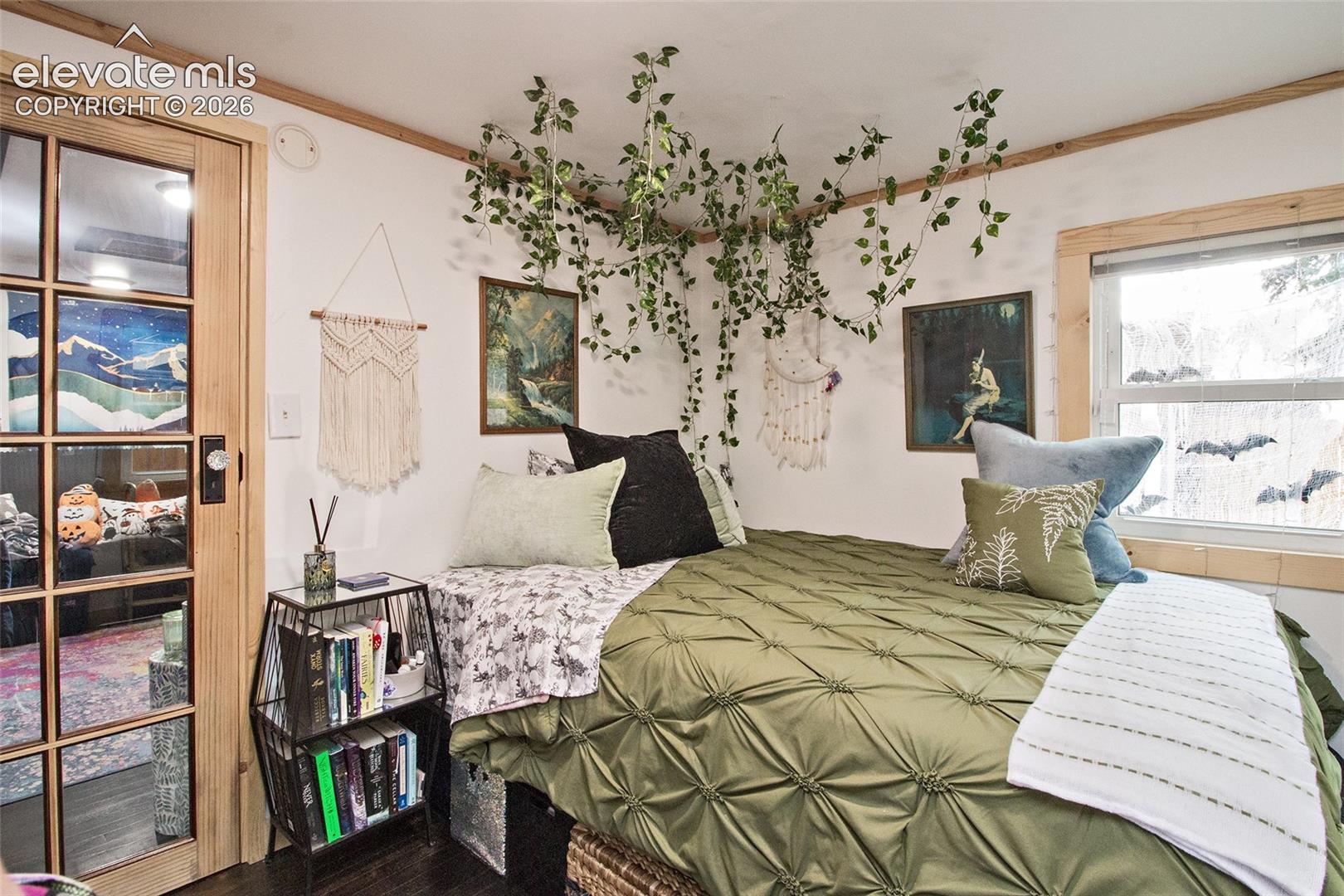 Interior space featuring wood-trim accents, a window with natural light, and a multi-pane glass door with a vintage-style knob