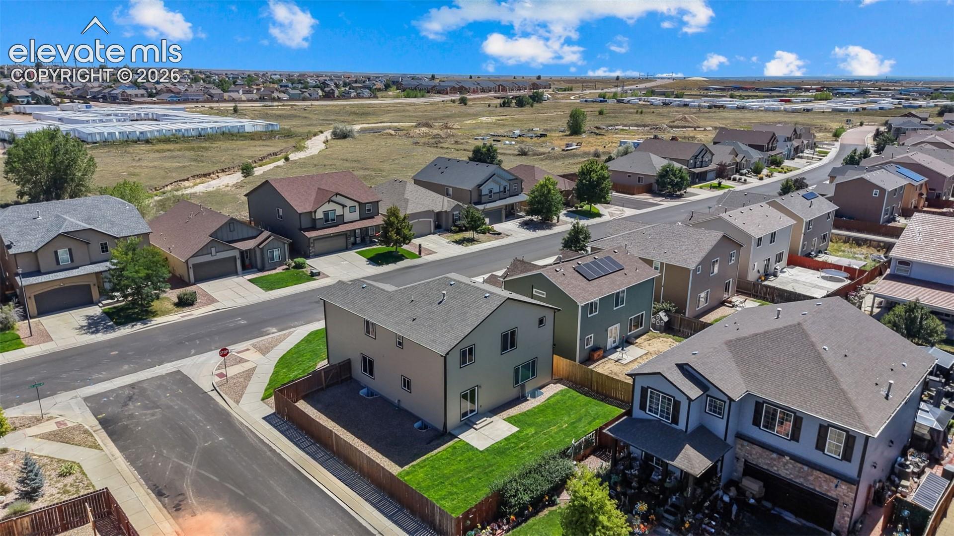 Residential street with uniform housing styles and varied exterior finishes