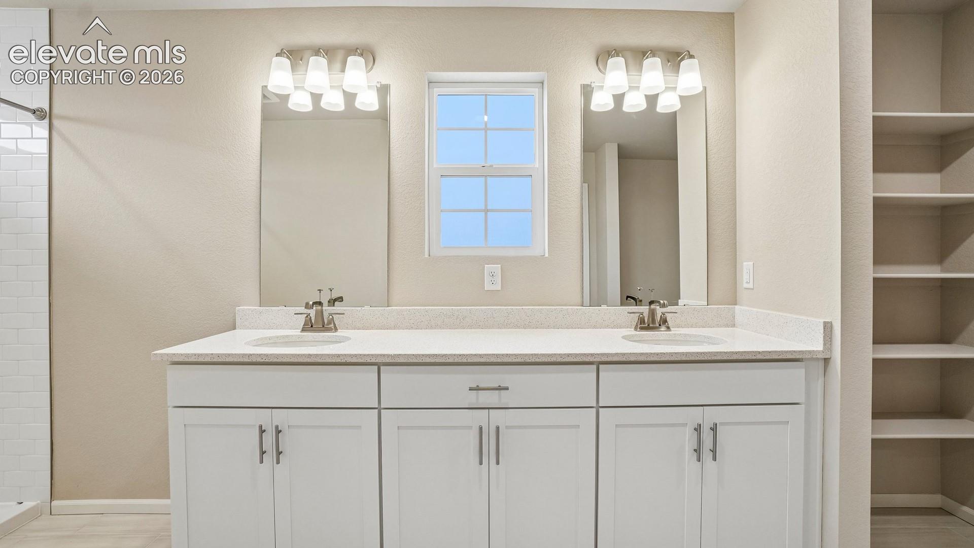 Dual vanity with undermount sinks, white cabinetry, and a light-toned countertop
*photos of a model home*