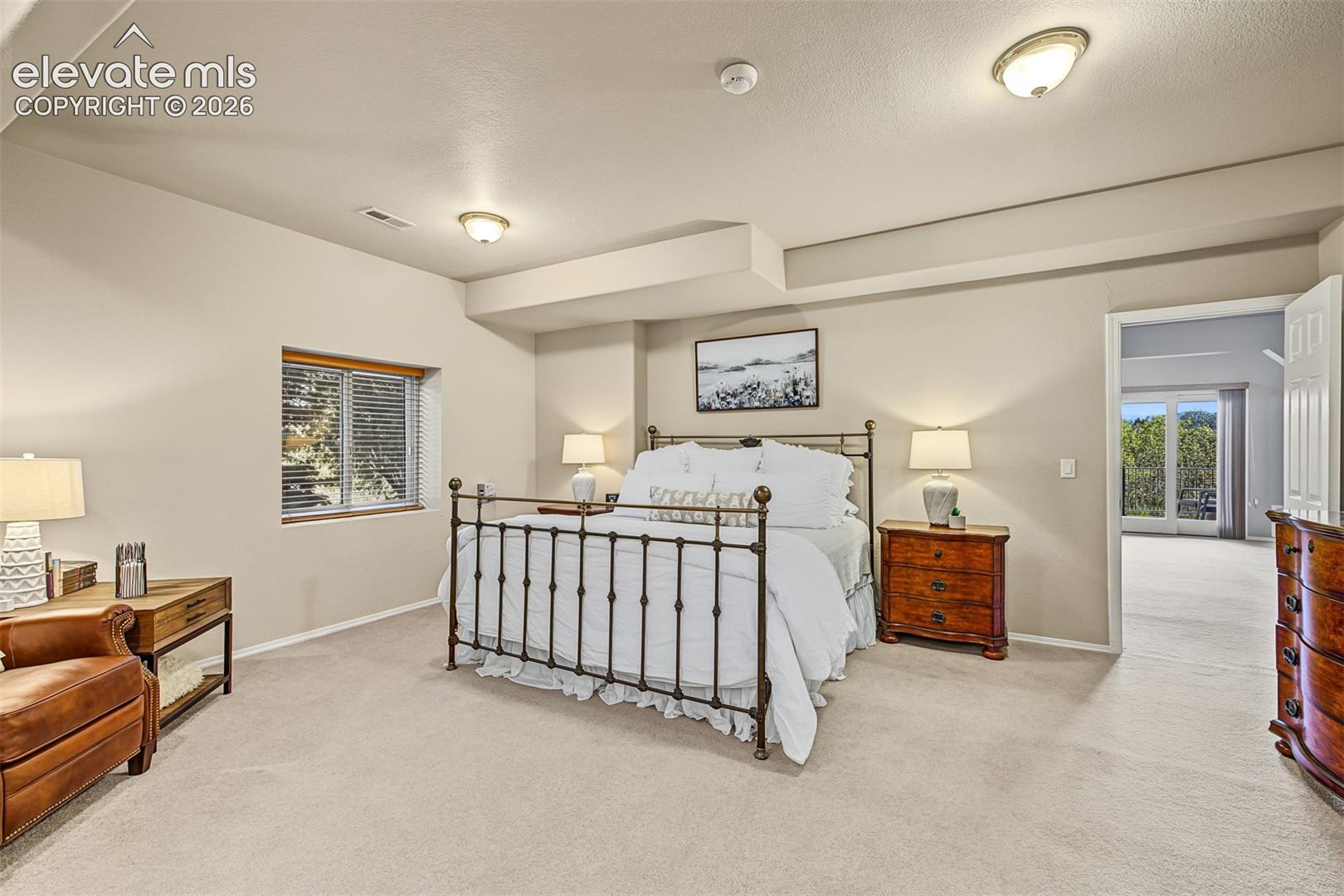 Spacious bedroom suite in the full walkout basement, featuring a sitting area, natural light, and access to its own full bathroom with shower and laundry room.
