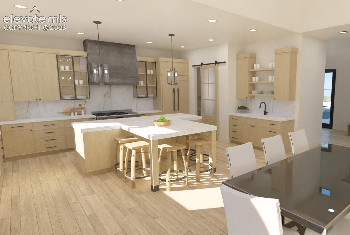 Light wood-finish flooring complements custom cabinetry with integrated appliances