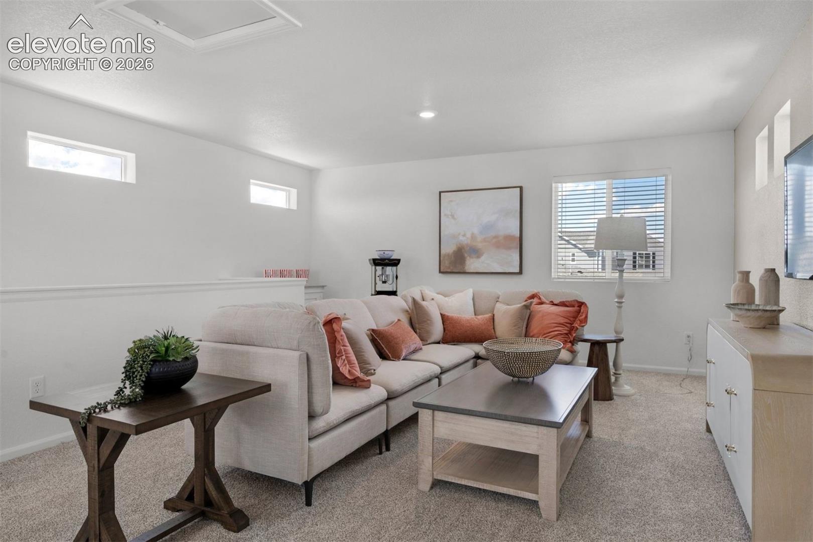 Carpeted flooring with multiple windows, recessed lighting, and a partial wall with railing
*photos of a model home*