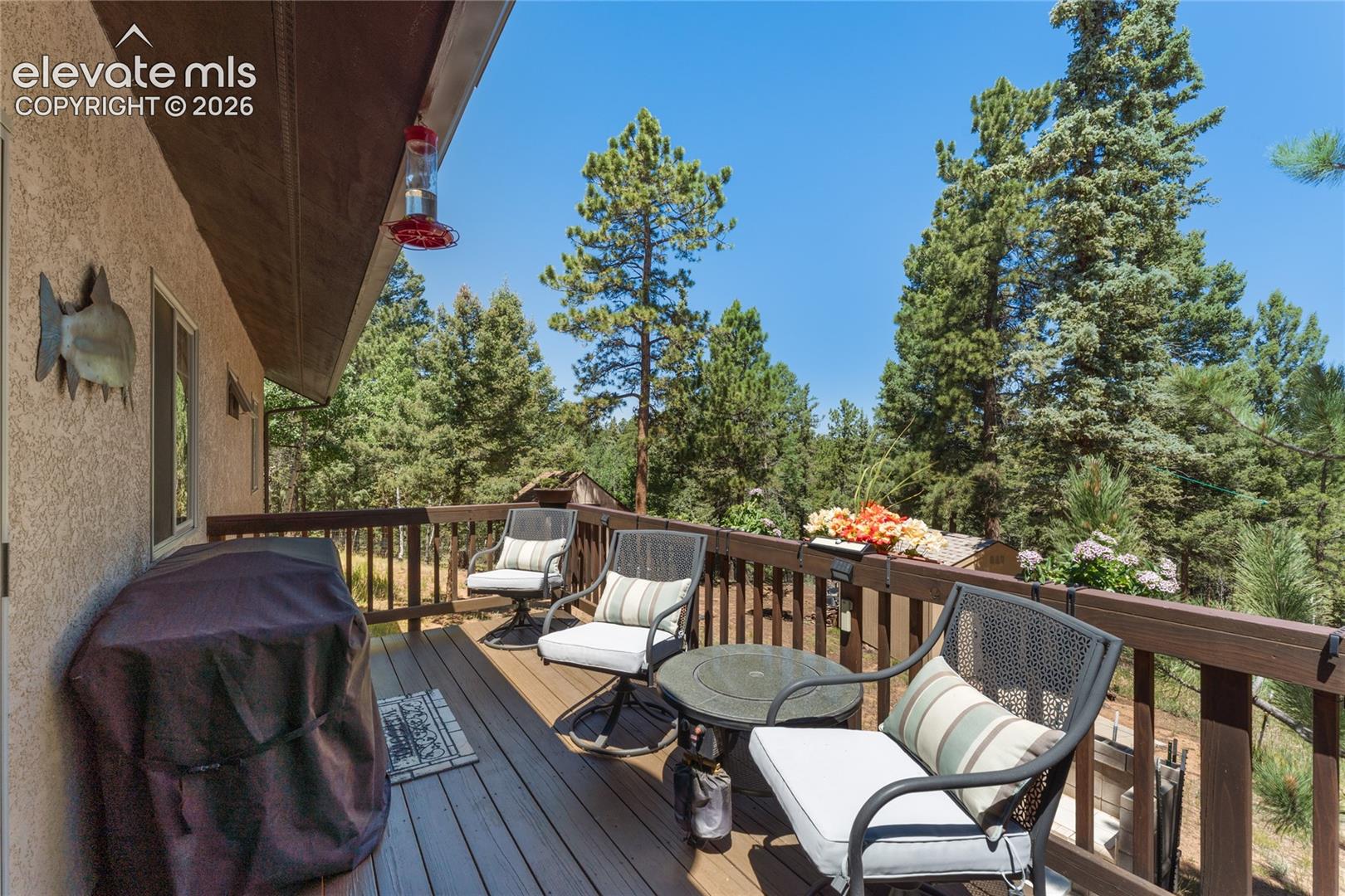 Spacious outdoor deck with wood-finish flooring and a wood railing