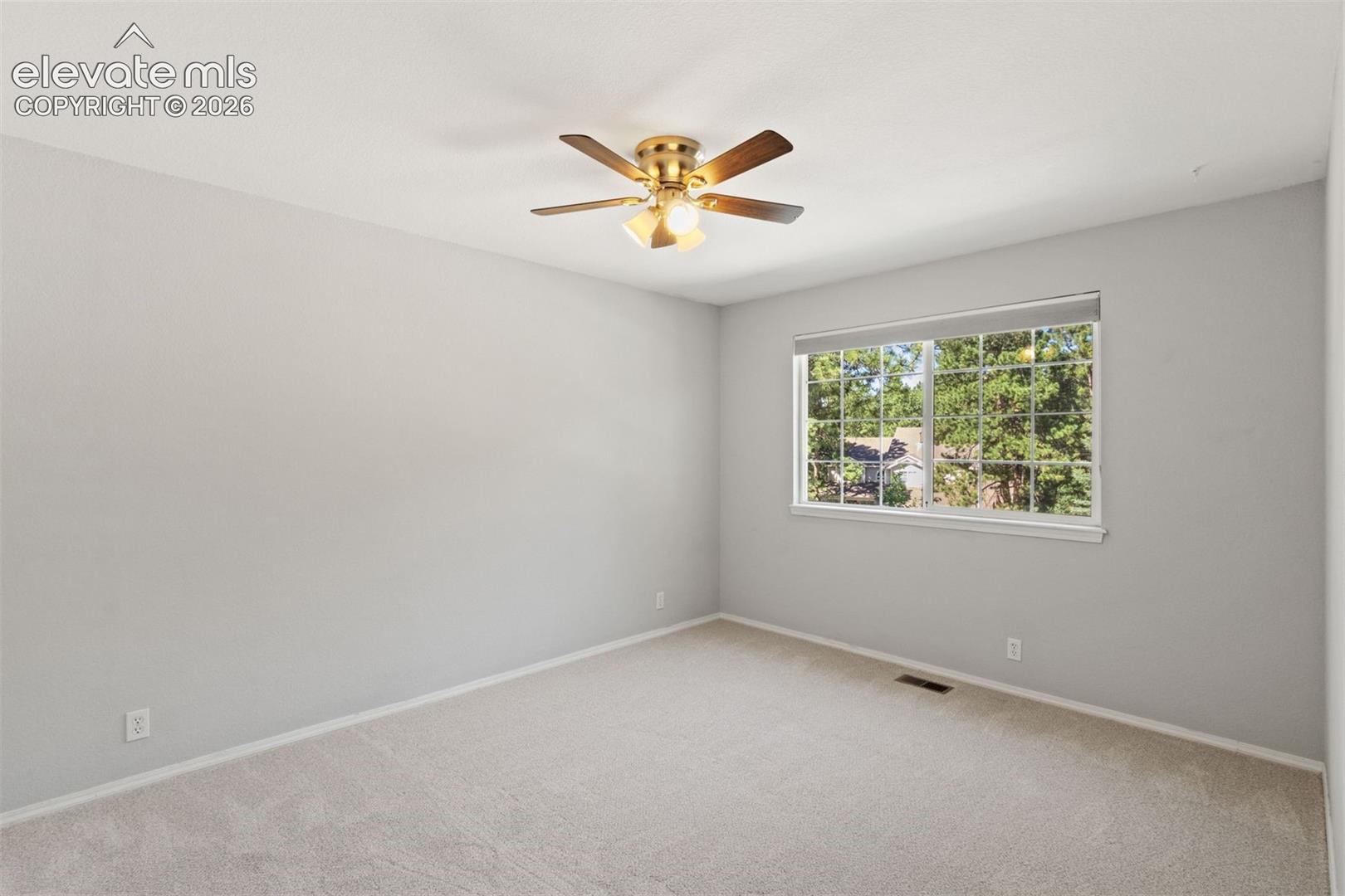 Upstairs bedroom with ceiling fan