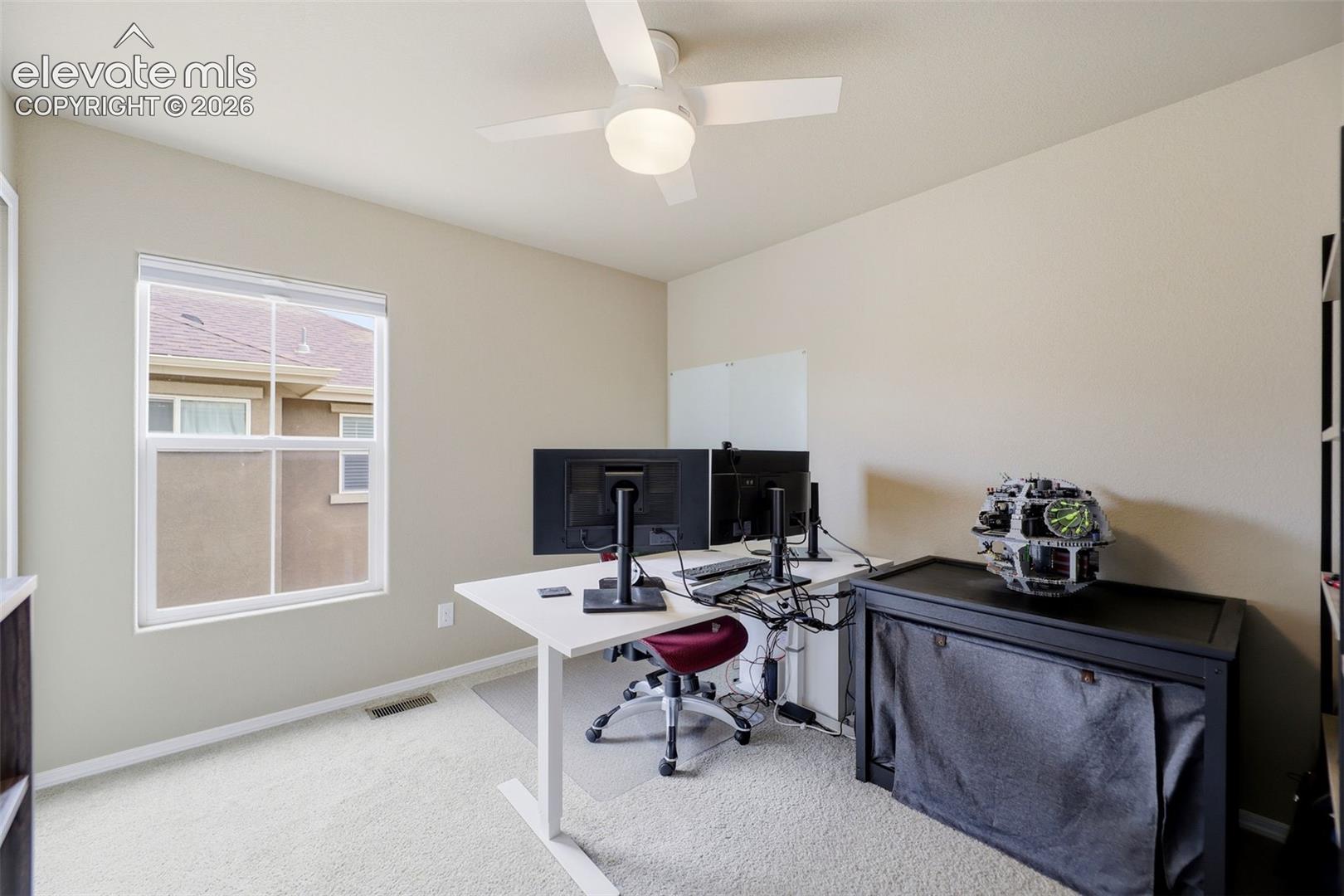 Neutral-toned walls complement the carpeted flooring