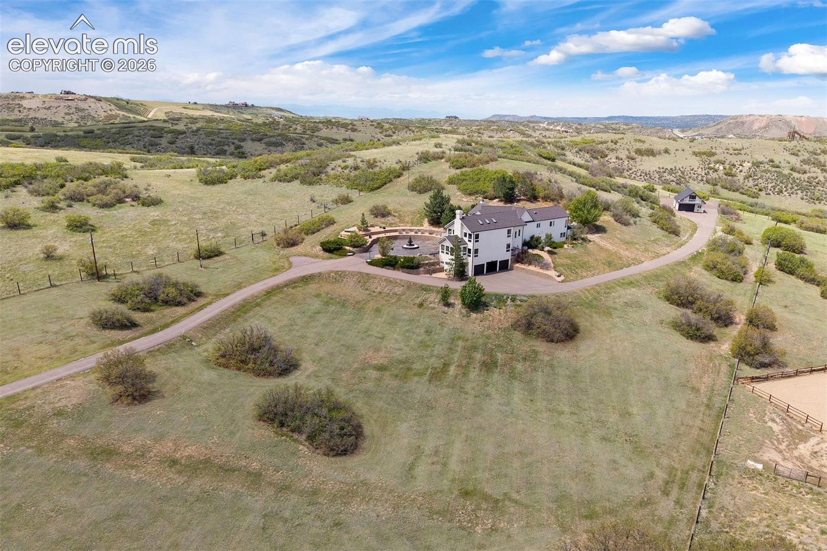 Nearly 10 private acres with the detached barn visible to the right and hundreds of acres of conservation open space beyond.
