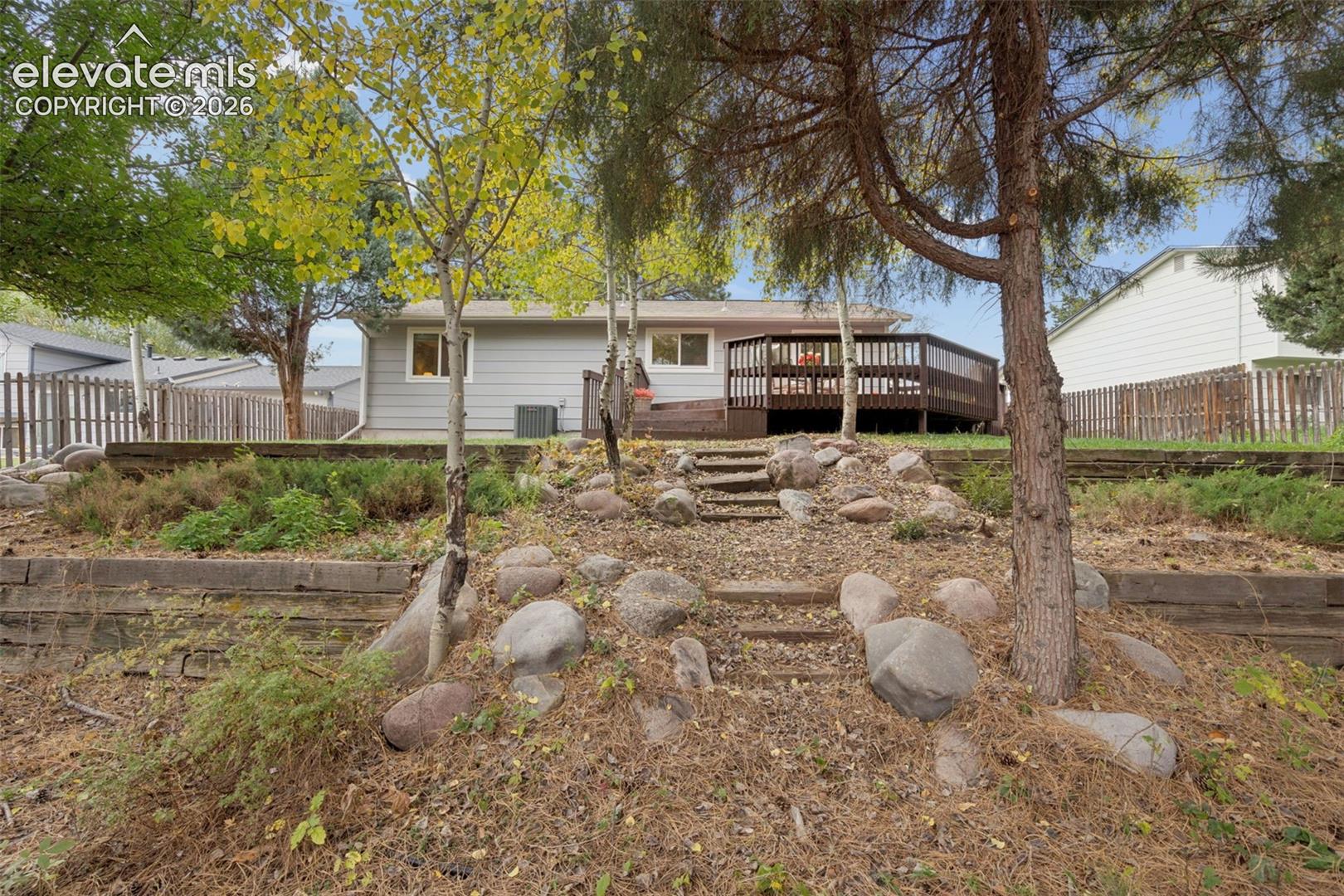 Rear tiered landscaping retaining walls and stone