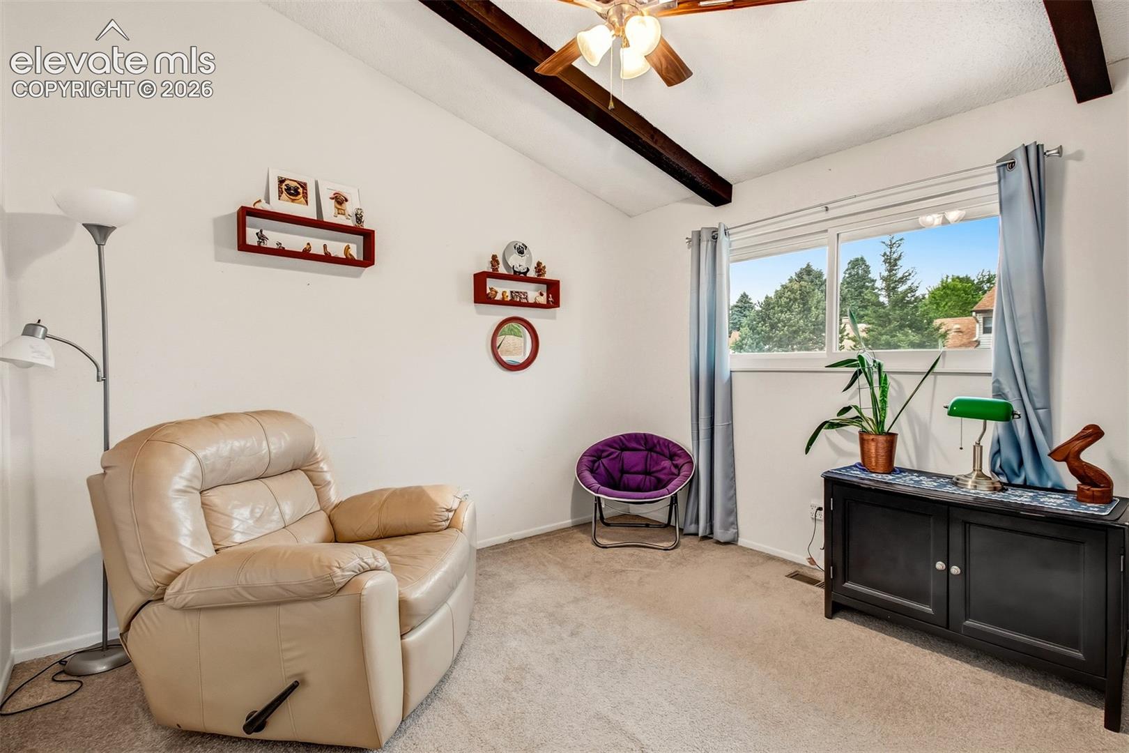 Vaulted ceiling featuring exposed structural beams and a ceiling fan with light fixture