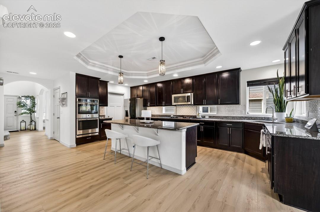 Gourmet, island, granite, walk in pantry, coffered ceiling, double oven, stainless steel appliances, gas stove