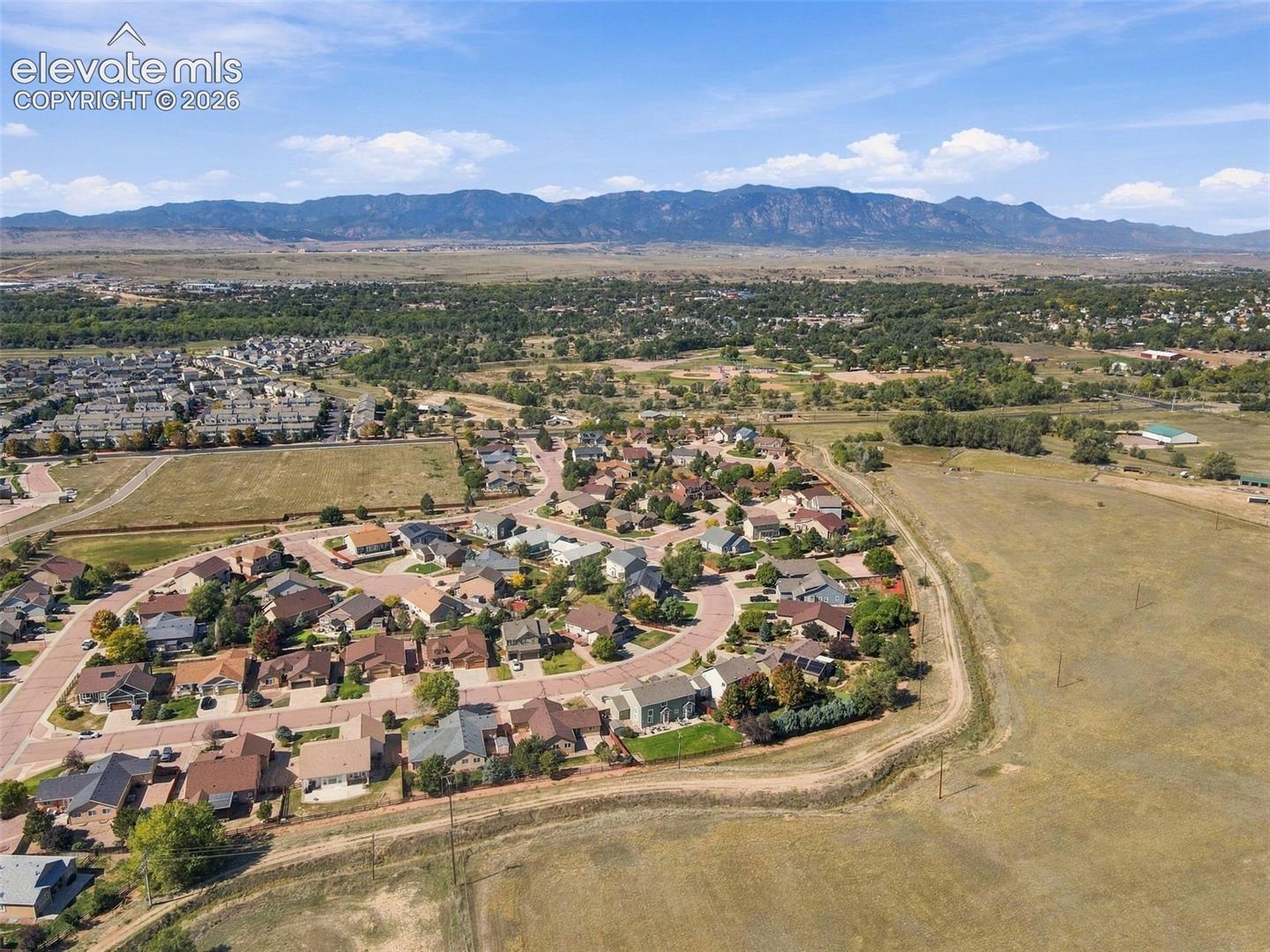 Aerial perspective showcasing a residential community with distant mountain scenery