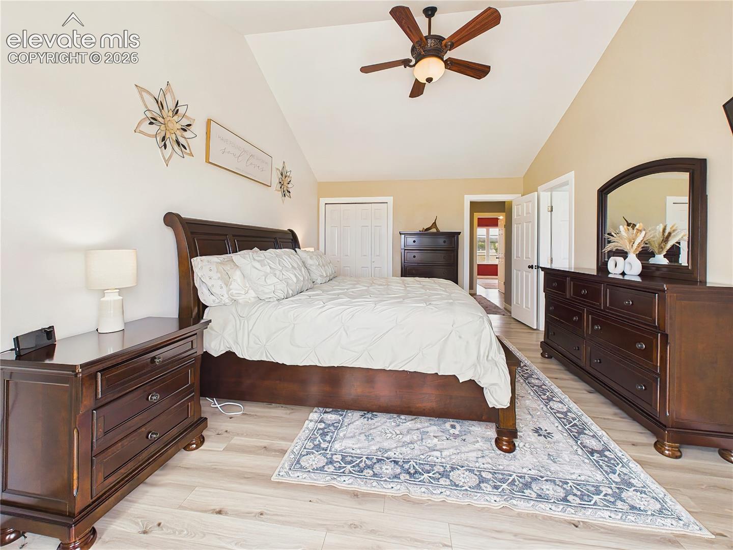 Spacious primary suite features vaulted ceilings, updated flooring, and a calming neutral color palette for a relaxing retreat.