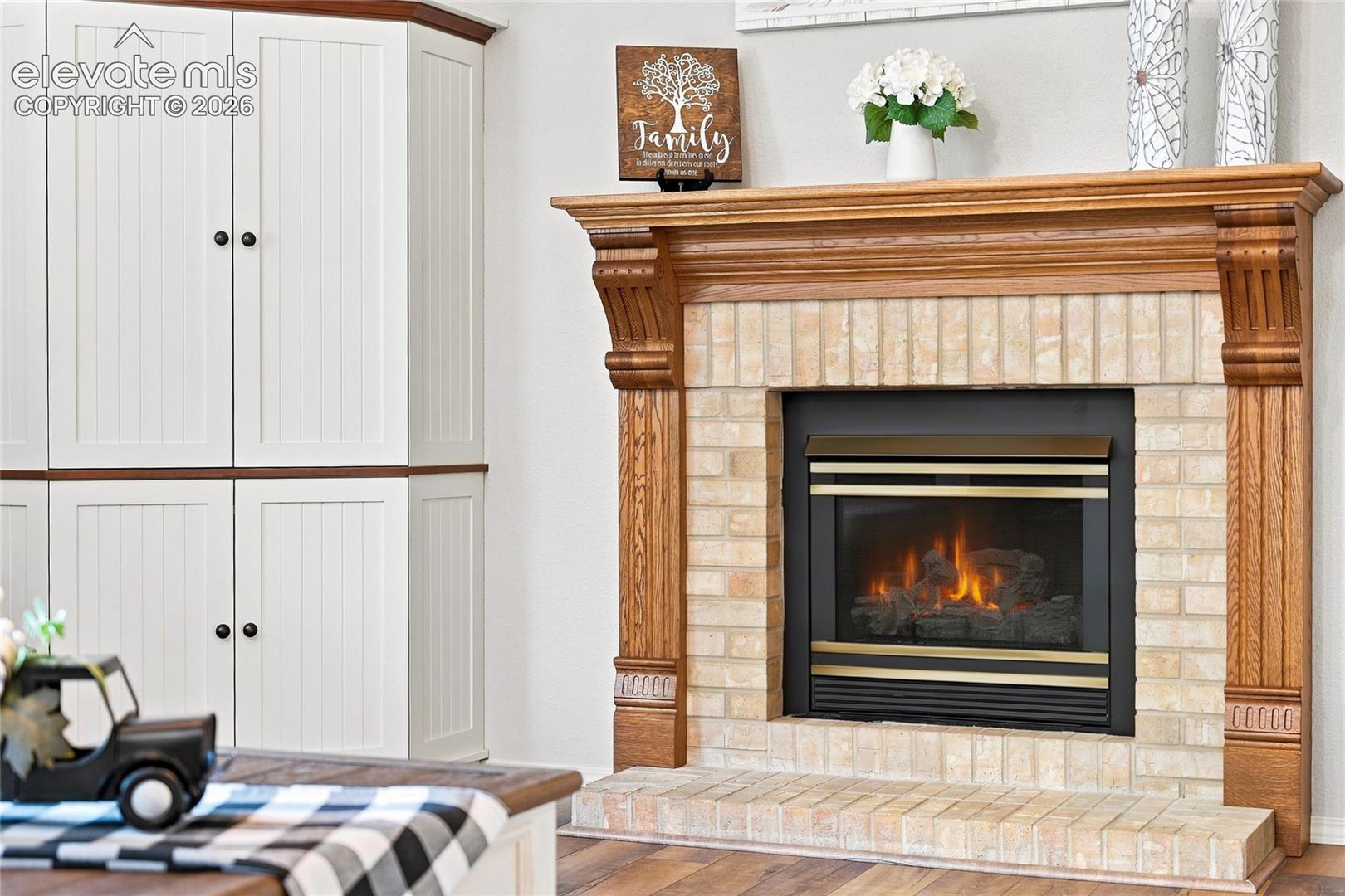 Gas fireplace with wood mantel