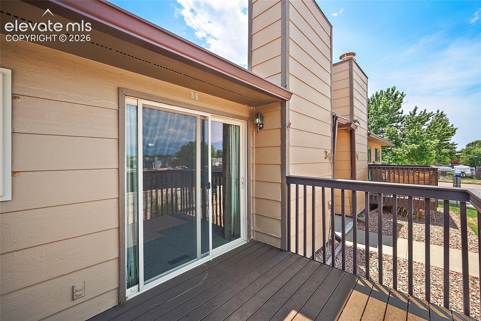 Private outdoor deck featuring durable dark-toned composite decking and a matching railing system