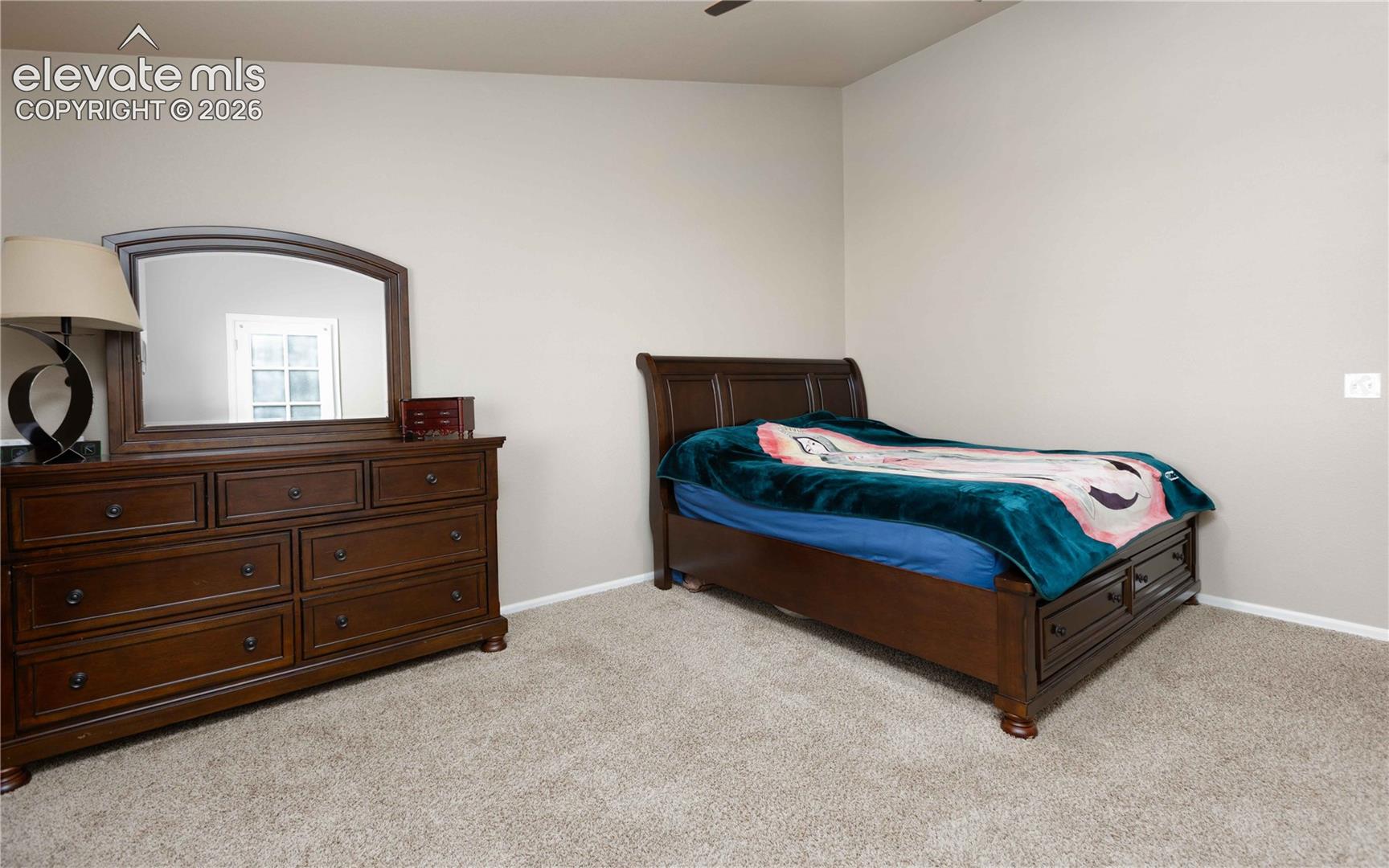 Neutral wall tones and wall-to-wall carpeting throughout