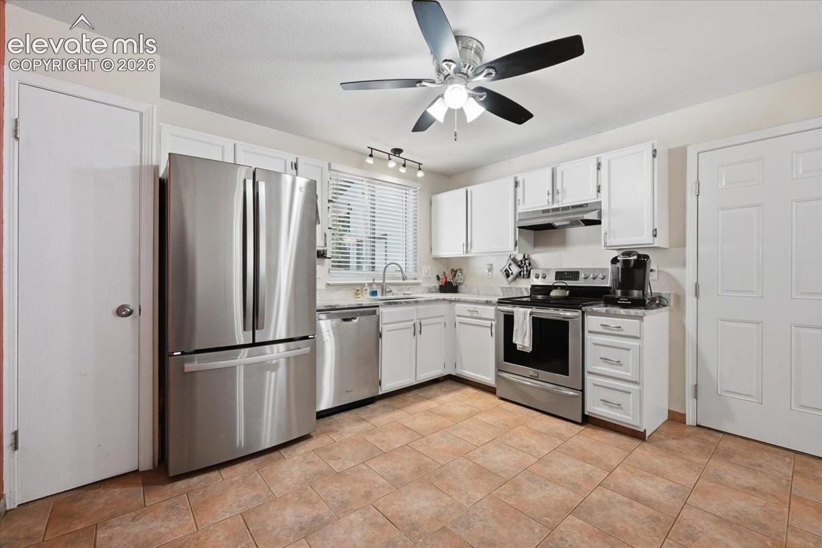 Kitchen offers a convenient pantry and a newer refrigerator.