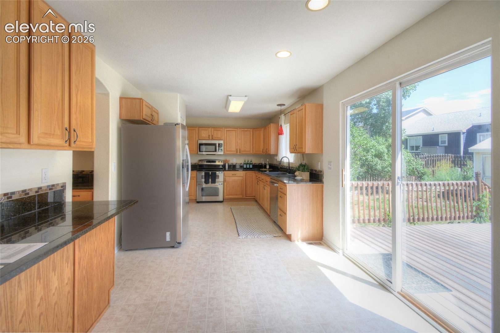 Spacious kitchen with a generous amount of cabinetry and granite counters!