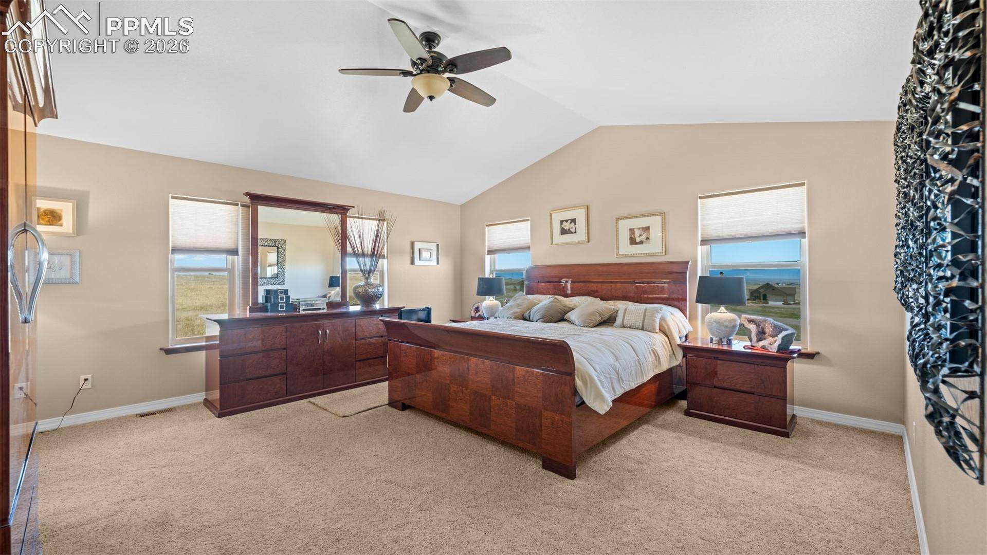 Bedroom with vaulted ceiling and a ceiling fan
