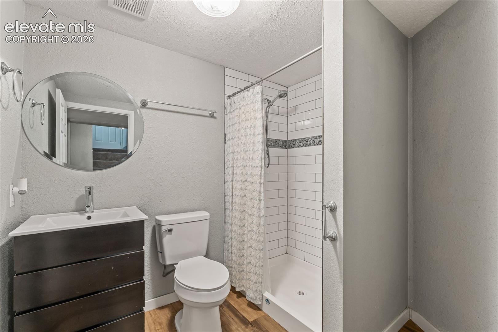 Bathroom featuring a built-in shower with white subway tile, a decorative tile accent band, and a glass enclosure