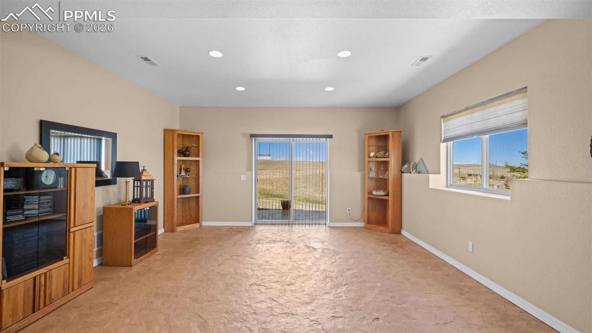 Walk out basement with polished, stamped concrete flooring and recessed lighting