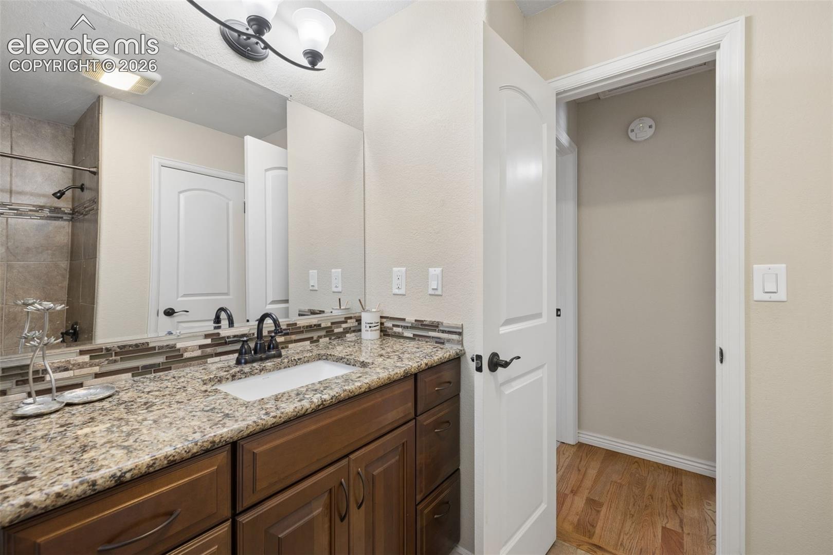 Full guest bathroom on the main level with granite countertop