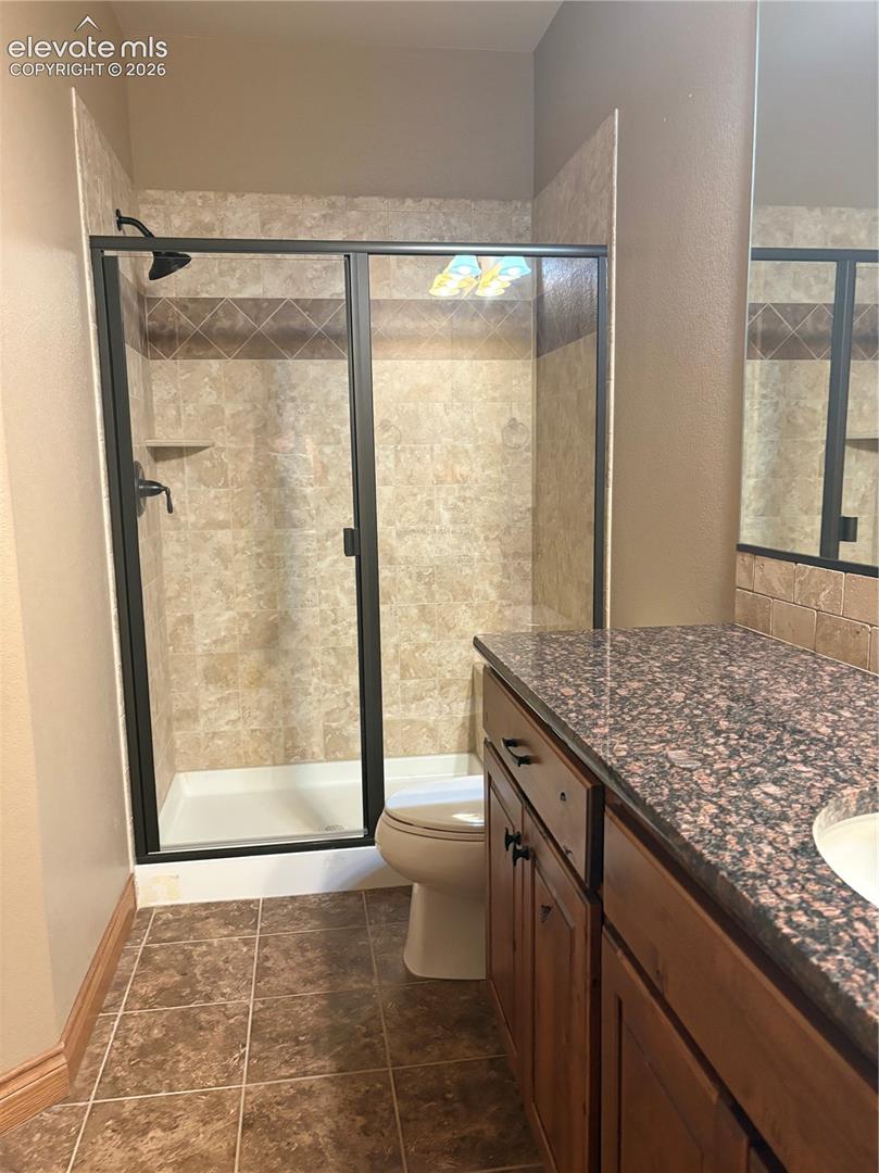 Shower in bathroom attached to lower back bedroom
