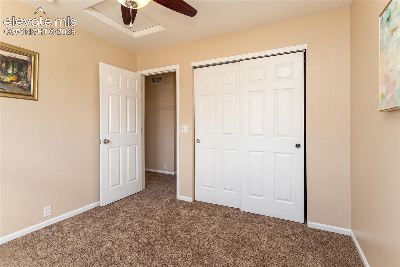 Ideal for family, guests, or a home office, this secondary bedroom includes a spacious closet and ceiling fan