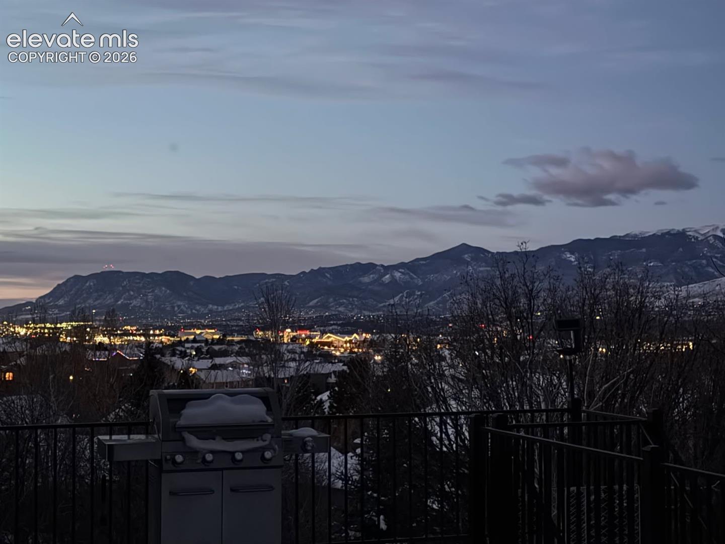 City lights with mountain views from deck