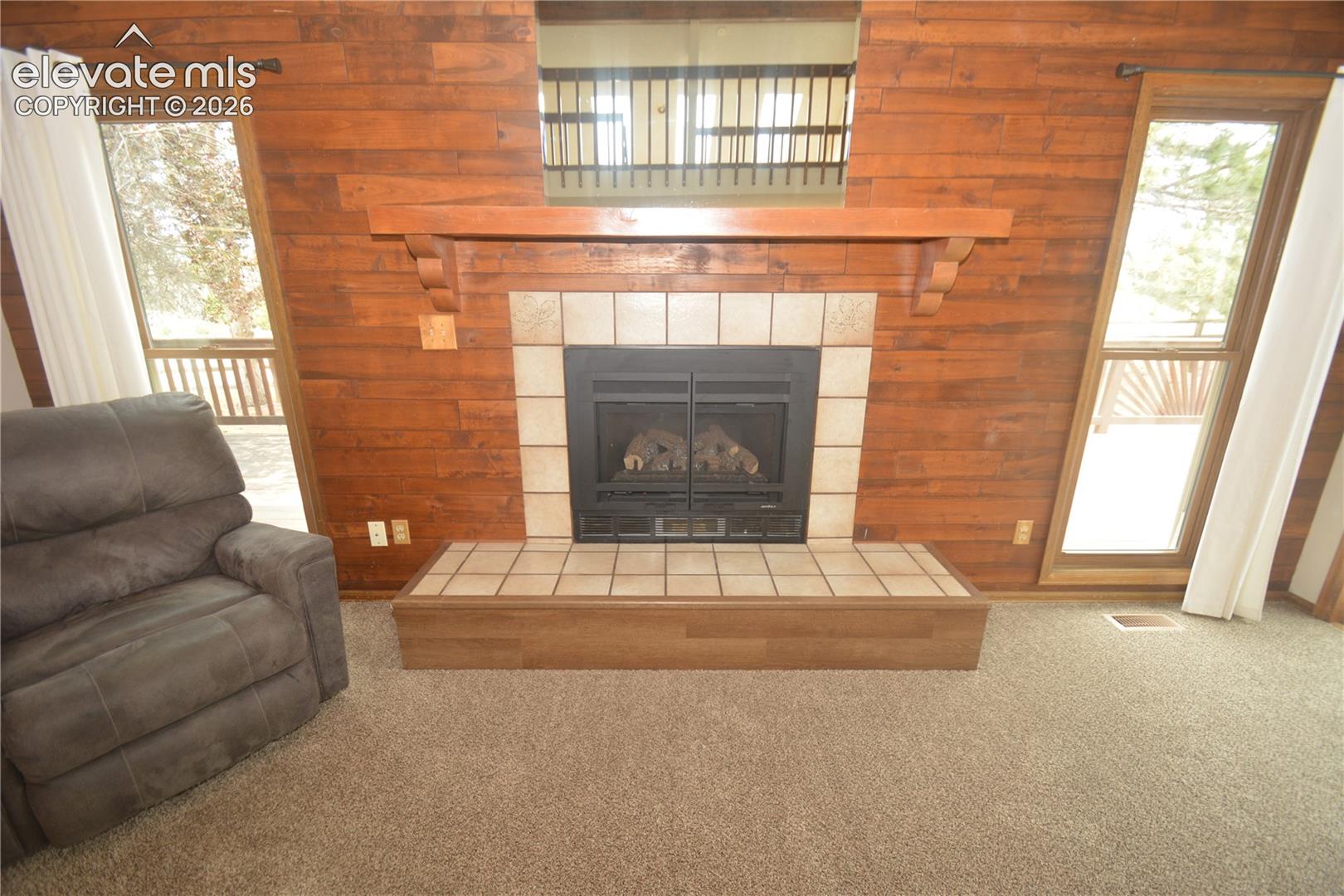 fireplace on far wall of living room.