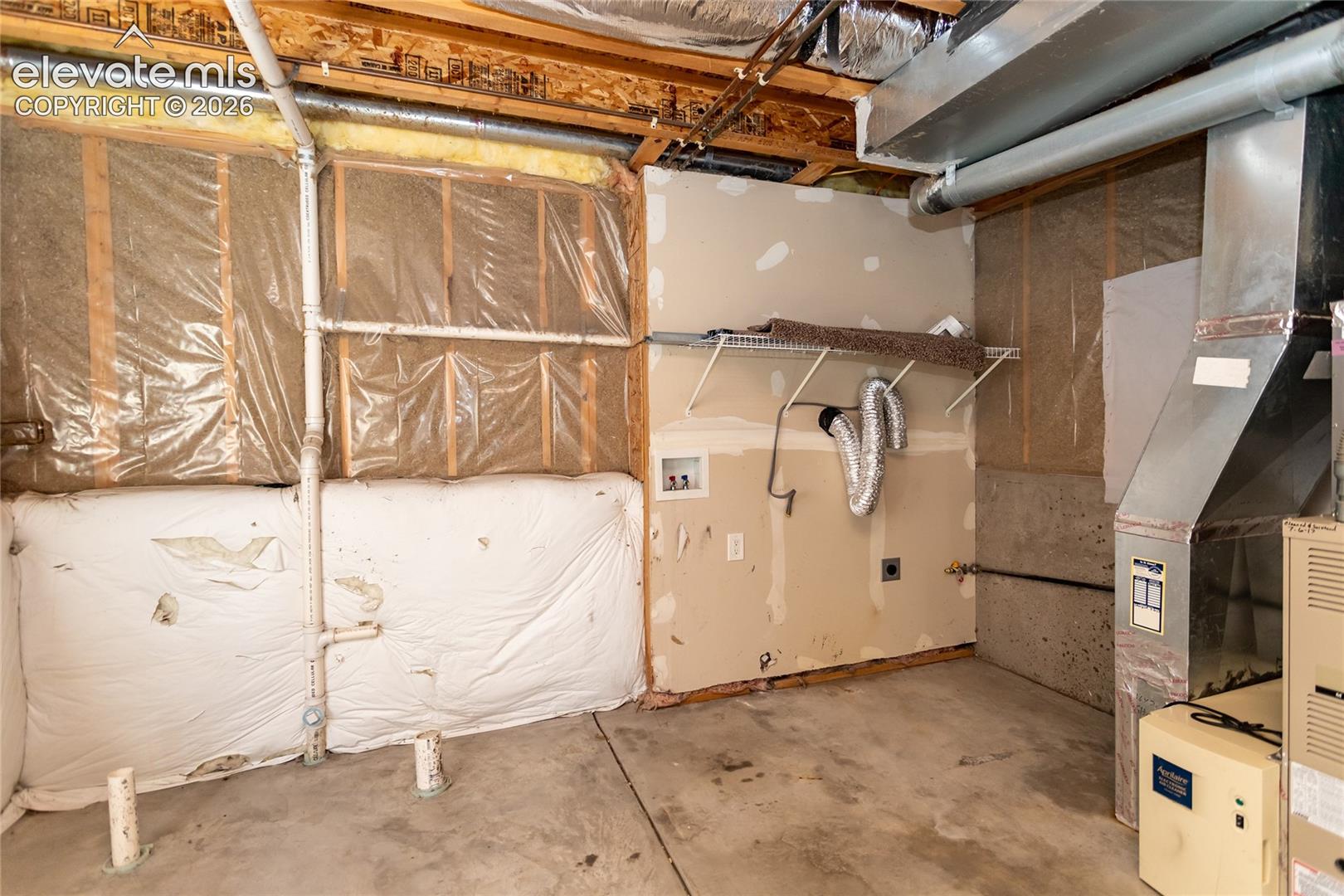 Dedicated basement utility space includes electric hookups for laundry facilities