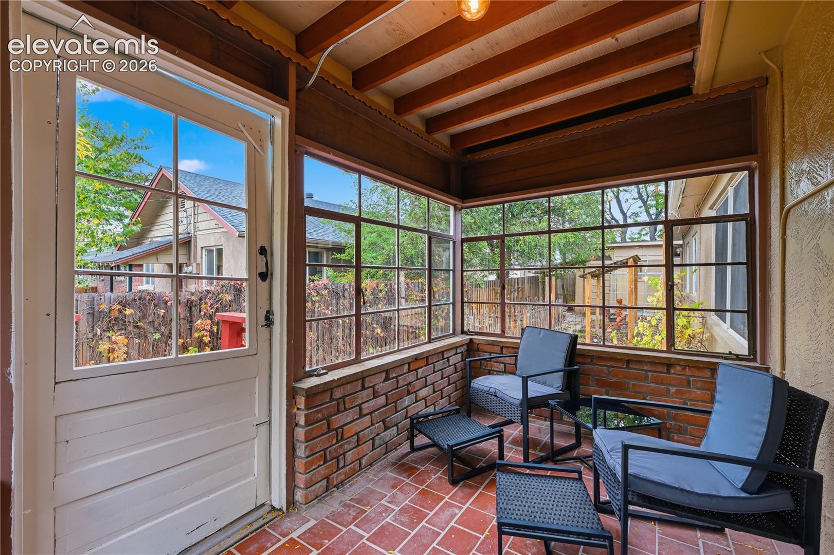 The charming sun room off the back of the kitchen. Another place to enjoy the outdoors without being outdoors.