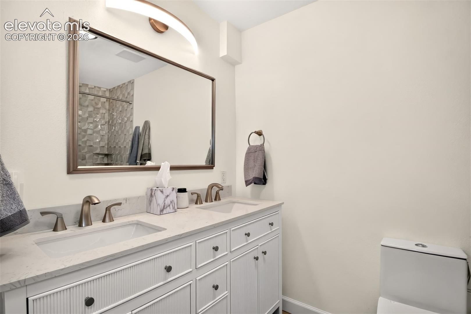 Double sink vanity and updated lighting in the private primary bath