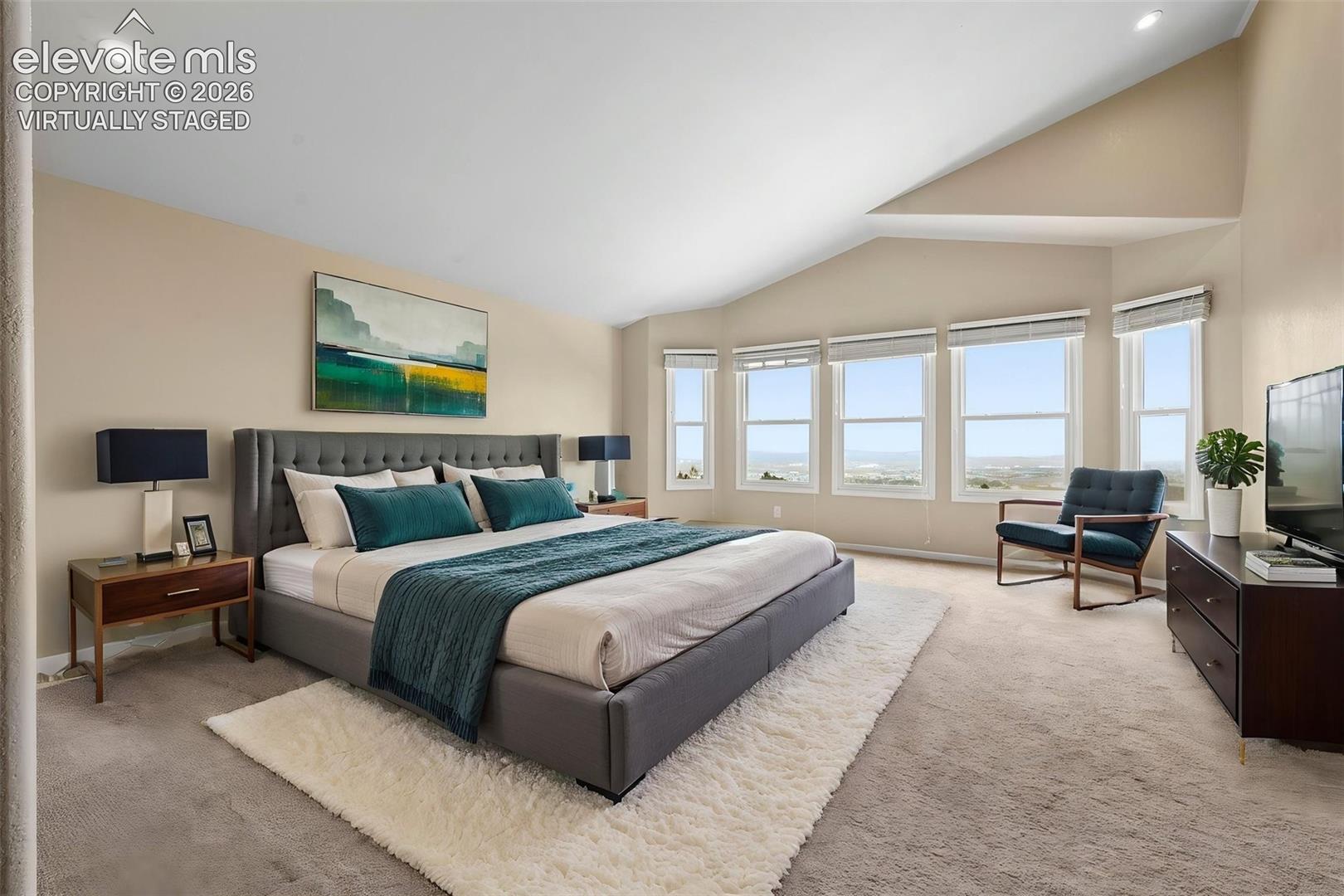virtually staged  primary bedroom overlooking the city!
