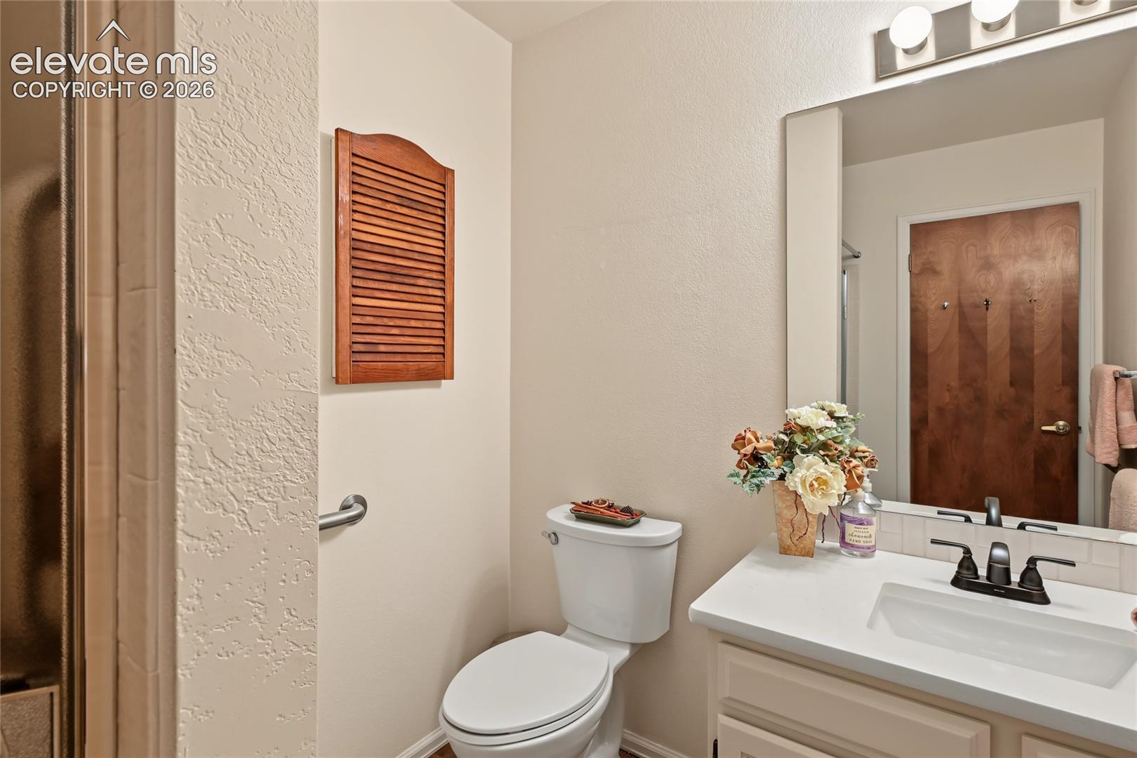 White vanity with an integrated sink and bronze-finish faucet