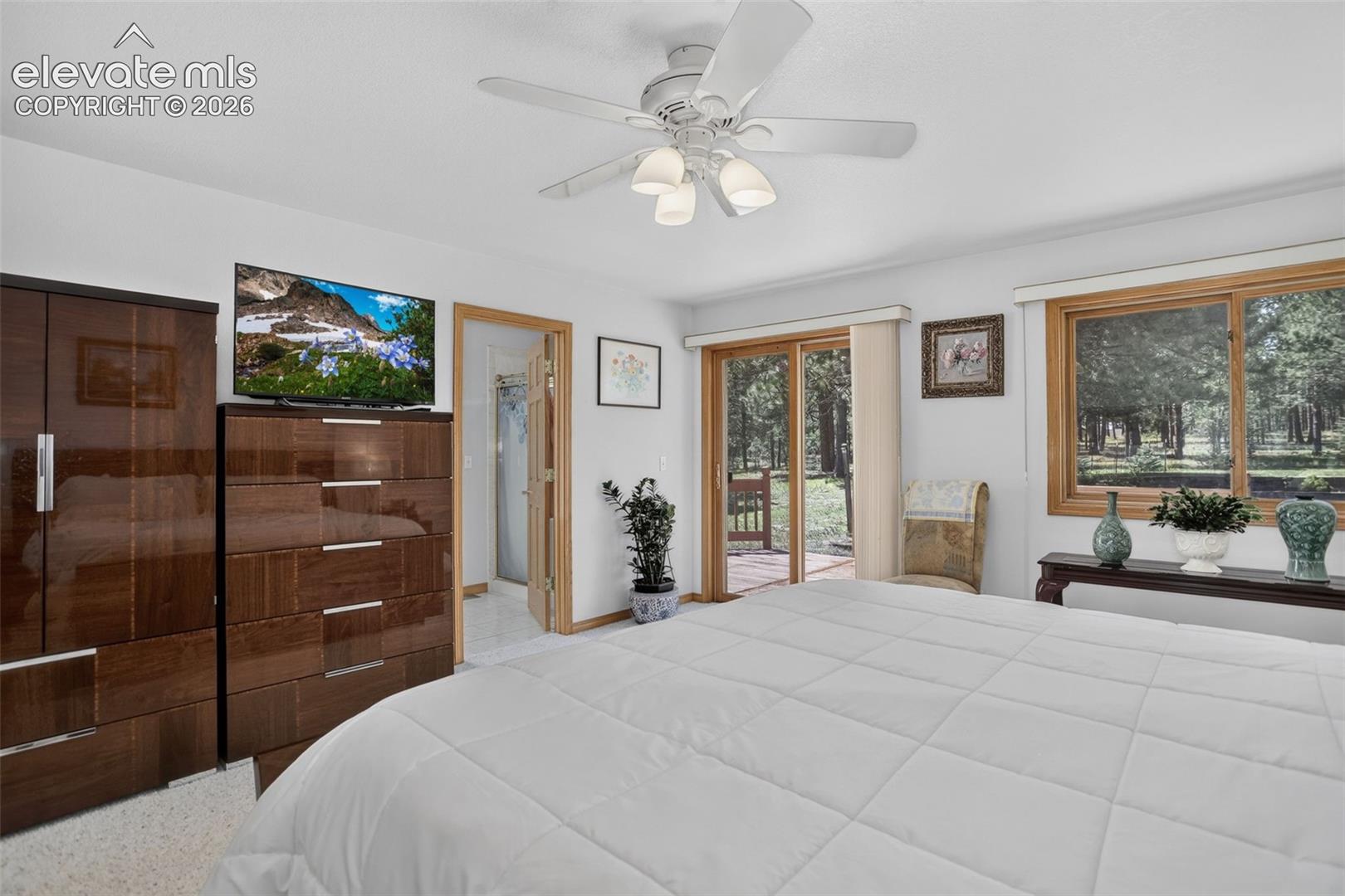 Primary bedroom with walk out to back deck and en suite bathroom.