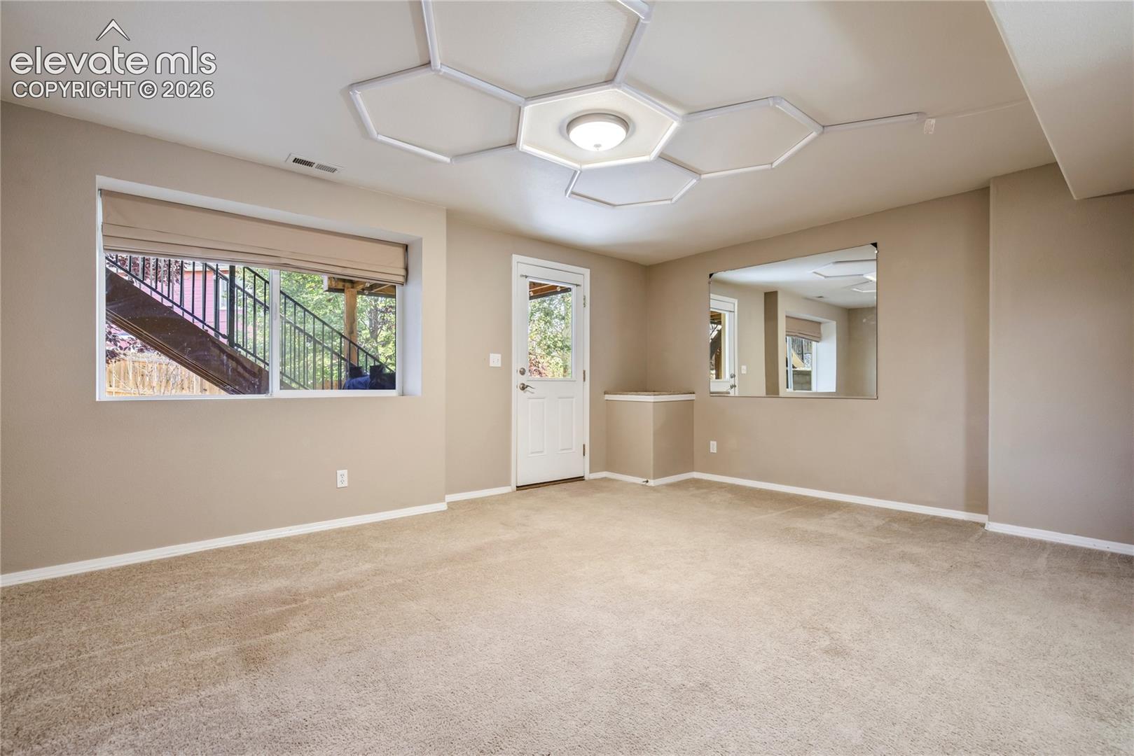 The basement family room offers flexible space for movie nights, games or a second gathering area, with windows bringing natural light into the finished basement.