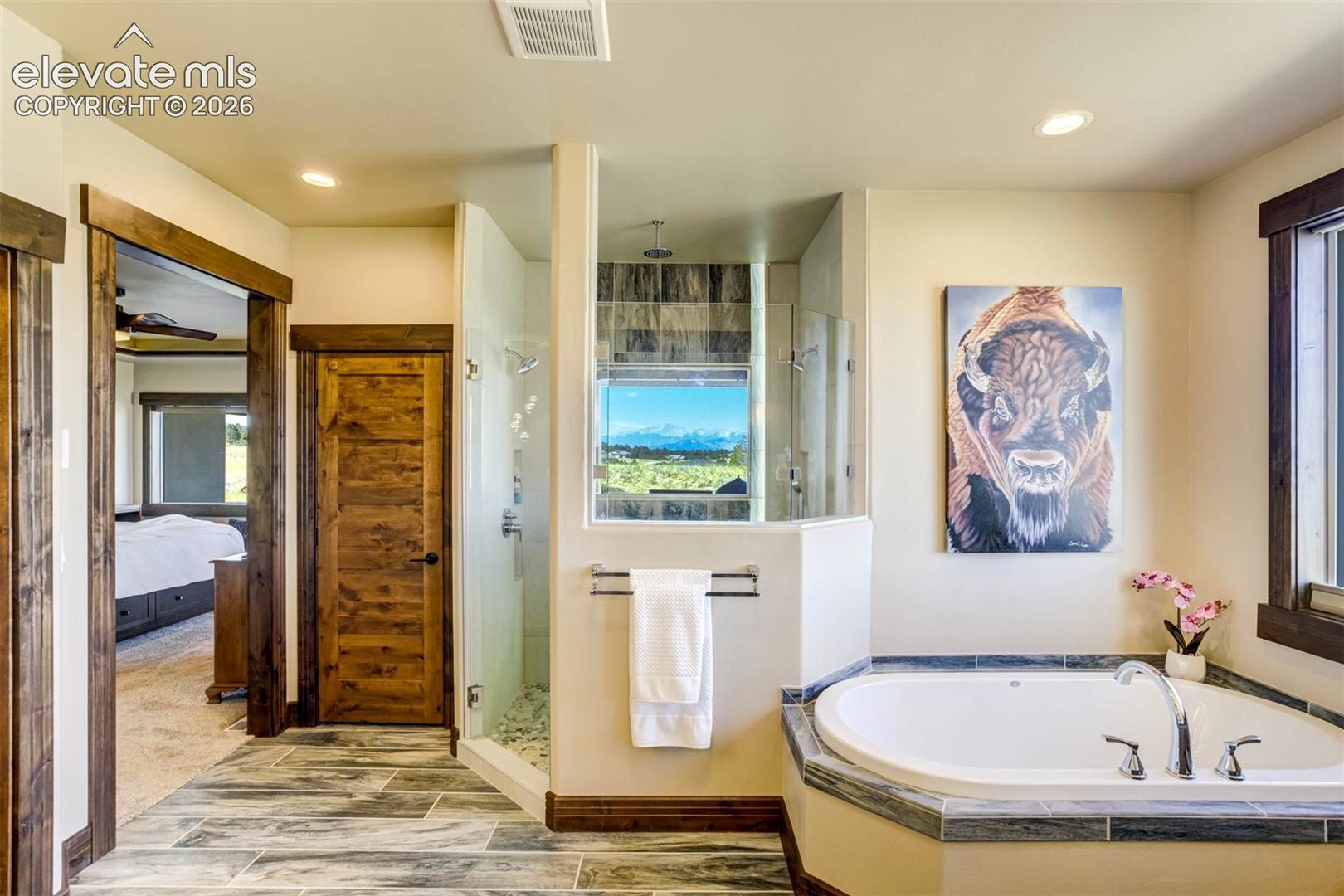 Master Bath features dual vanities, luxurious shower, soaking tub, separate water closet, and heated floors