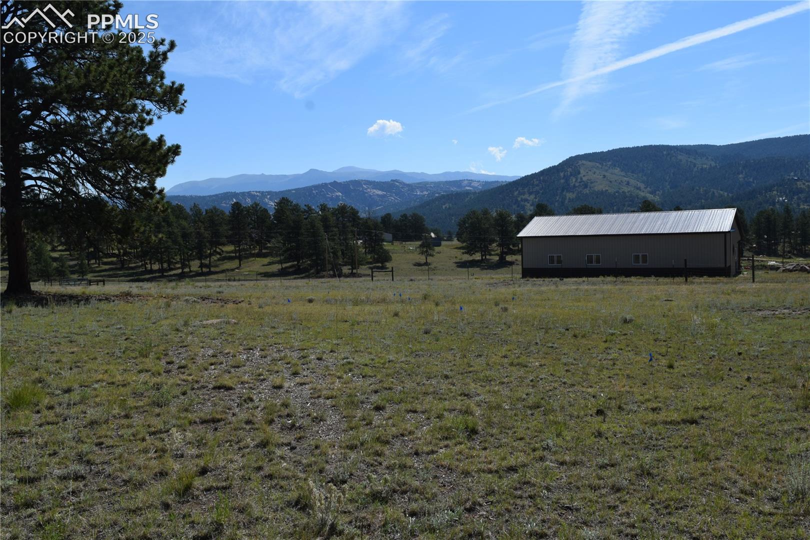 View of mountain backdrop with rural landscape