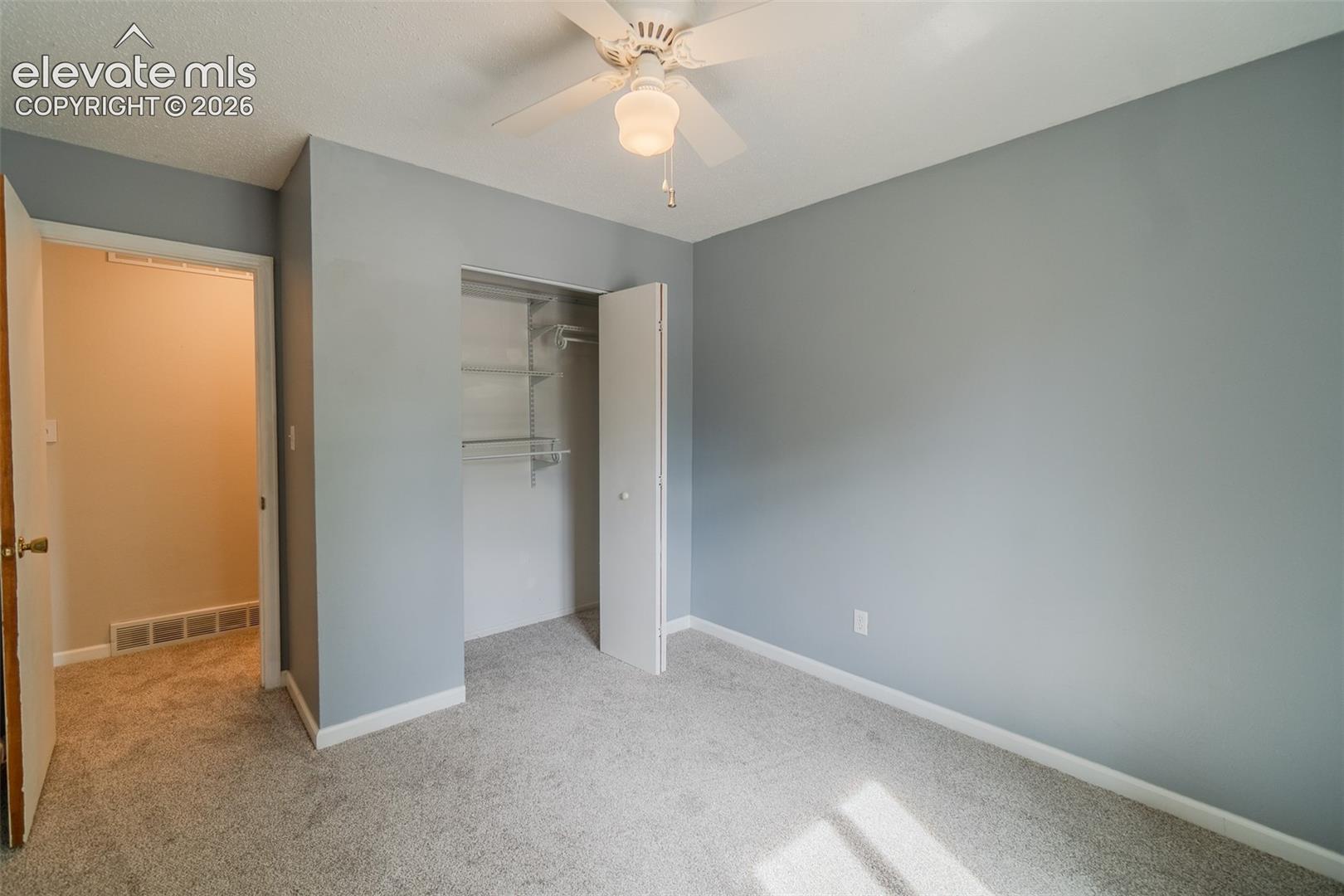 Plush carpet flooring paired with light gray walls