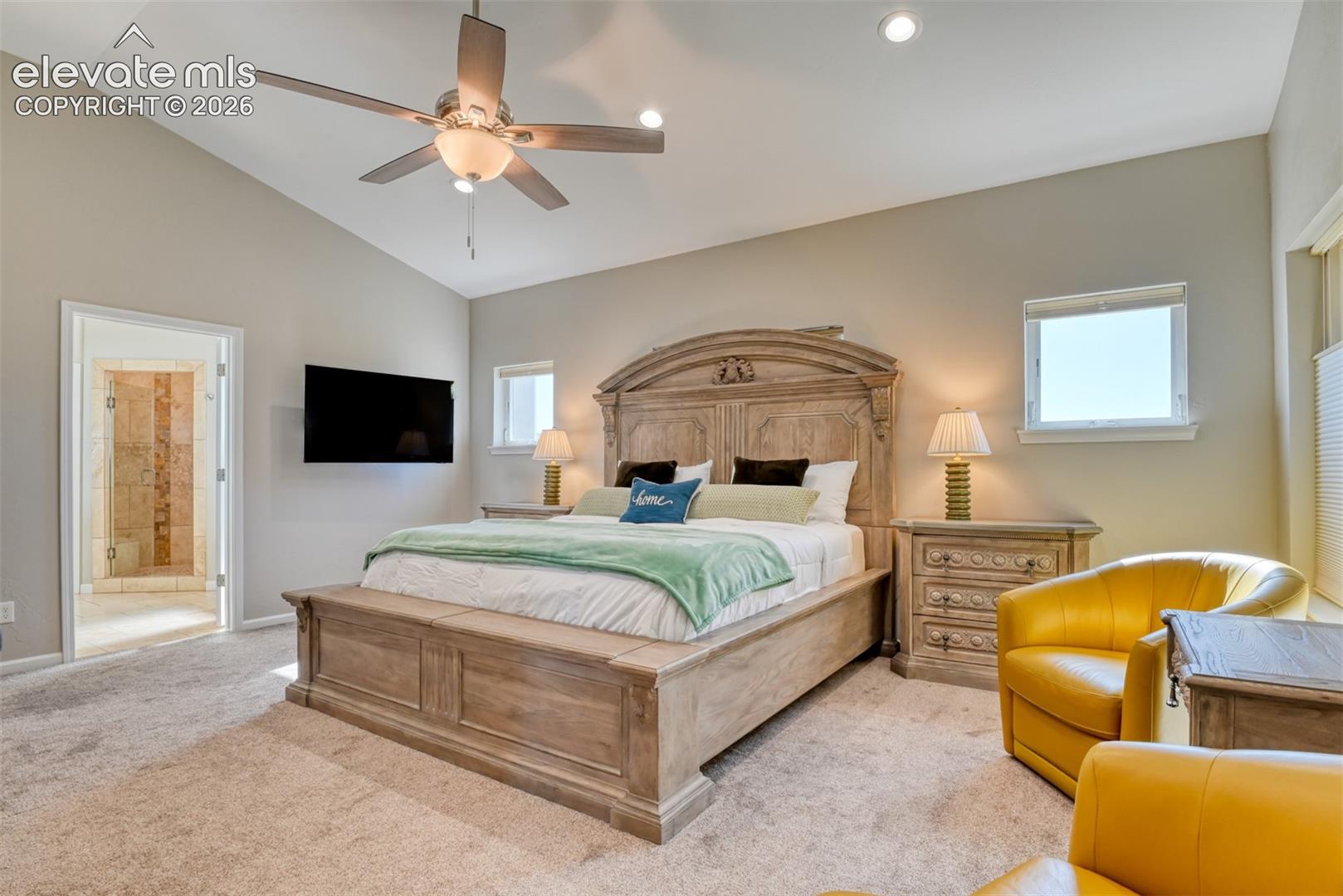 Vaulted ceiling, recessed lighting, ceiling fan, carpet flooring, walk in closet, walks out to covered patio.