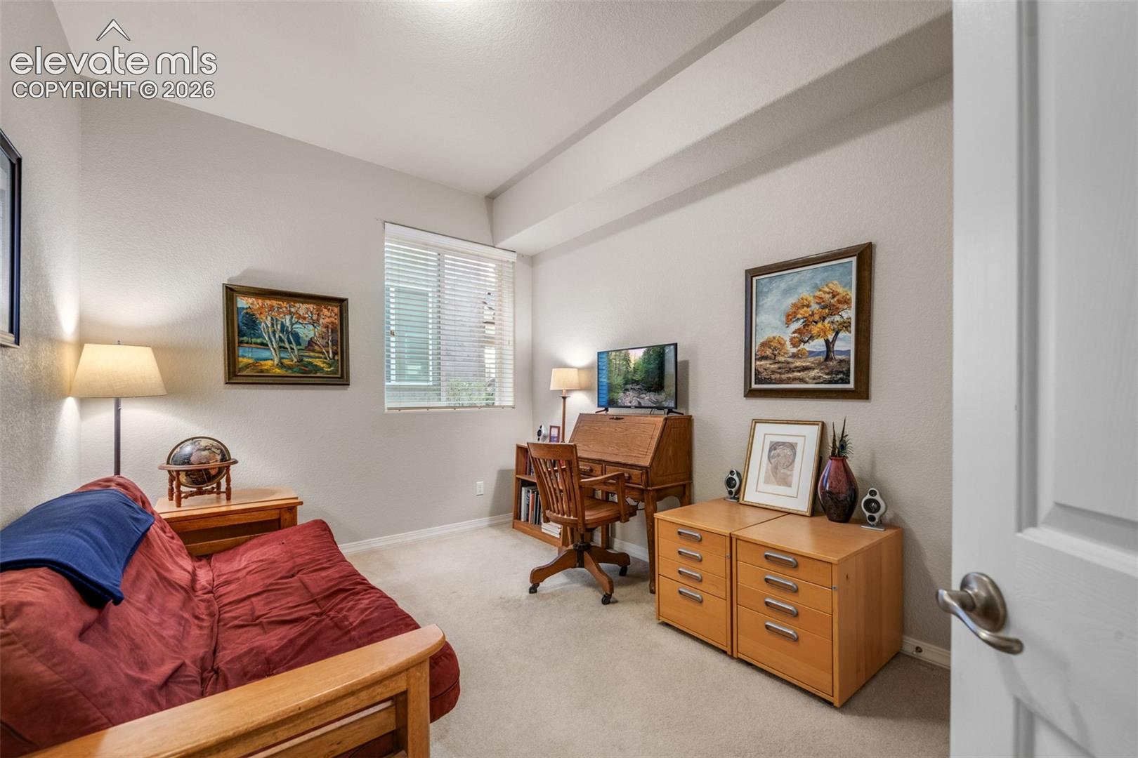 Recessed ceiling detail, window with horizontal blinds, neutral wall tones, and carpet flooring
